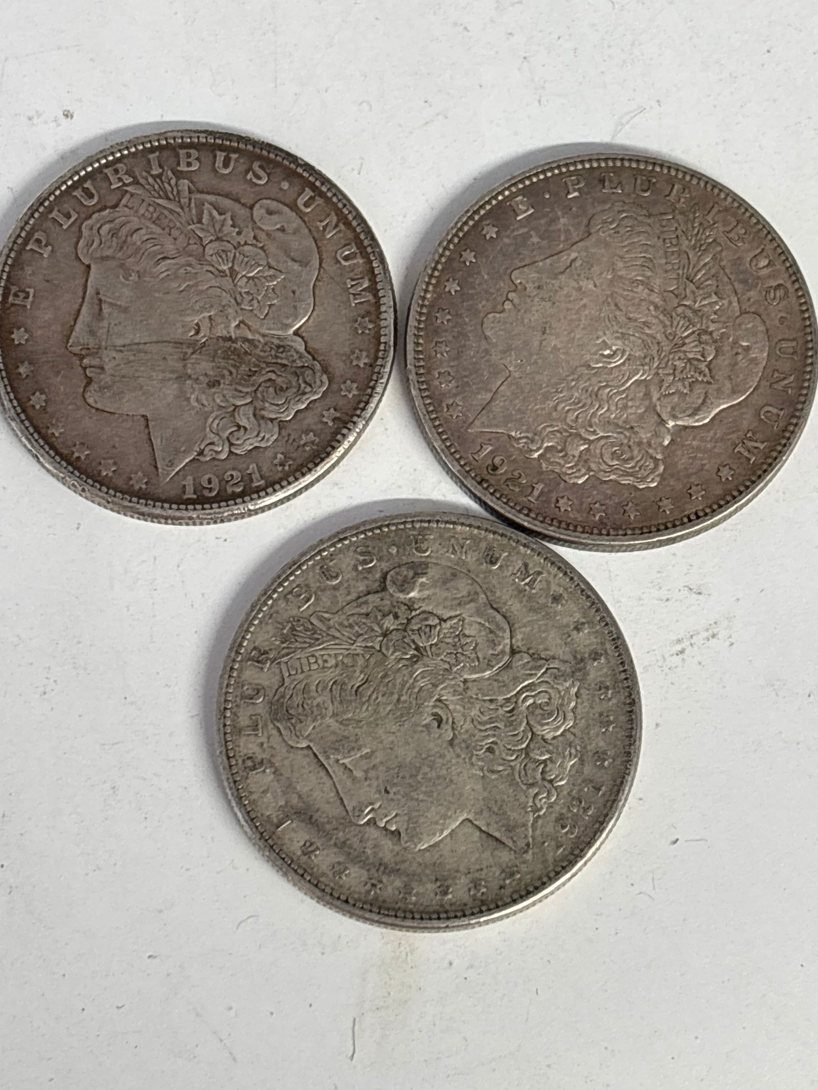 group of Three original dated 1921 Morgan American silver dollars; worn (1 of 5)