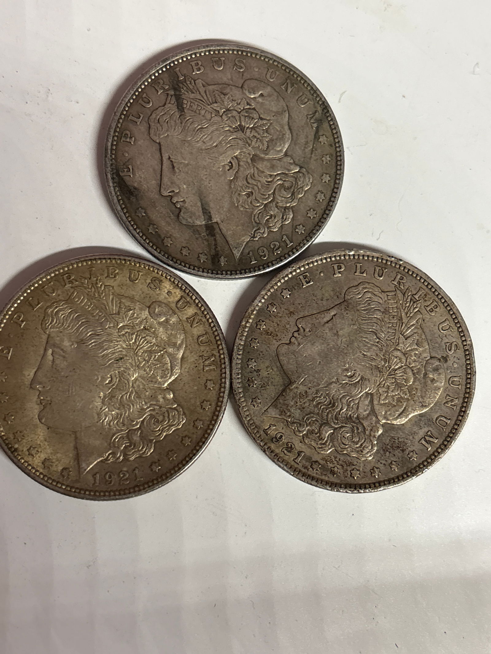 Three 1921 Morgan American silver dollars, worn (1 of 5)