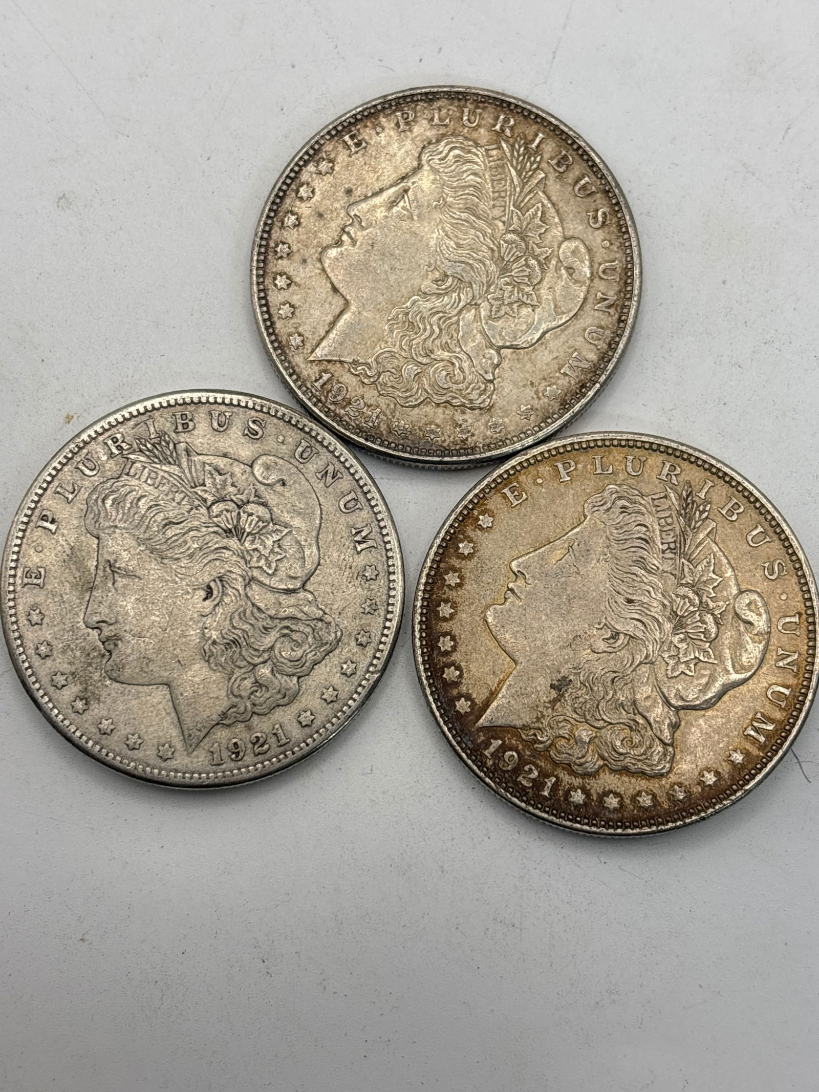 Three dated 1921 Morgan American silver dollars (1 of 5)