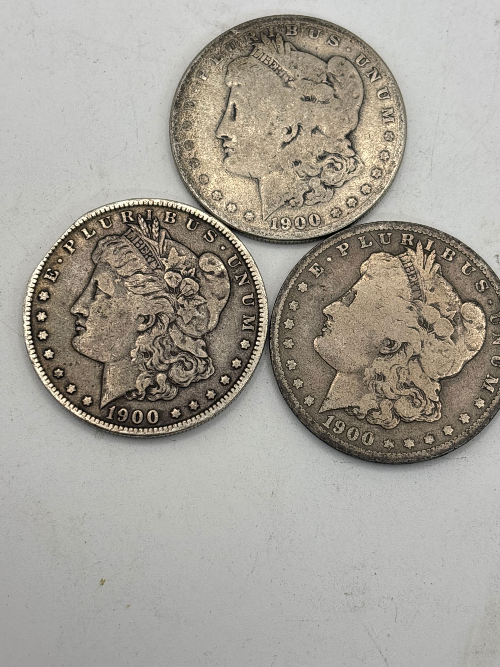 Three dated 1900 Morgan American silver dollars (1 of 5)