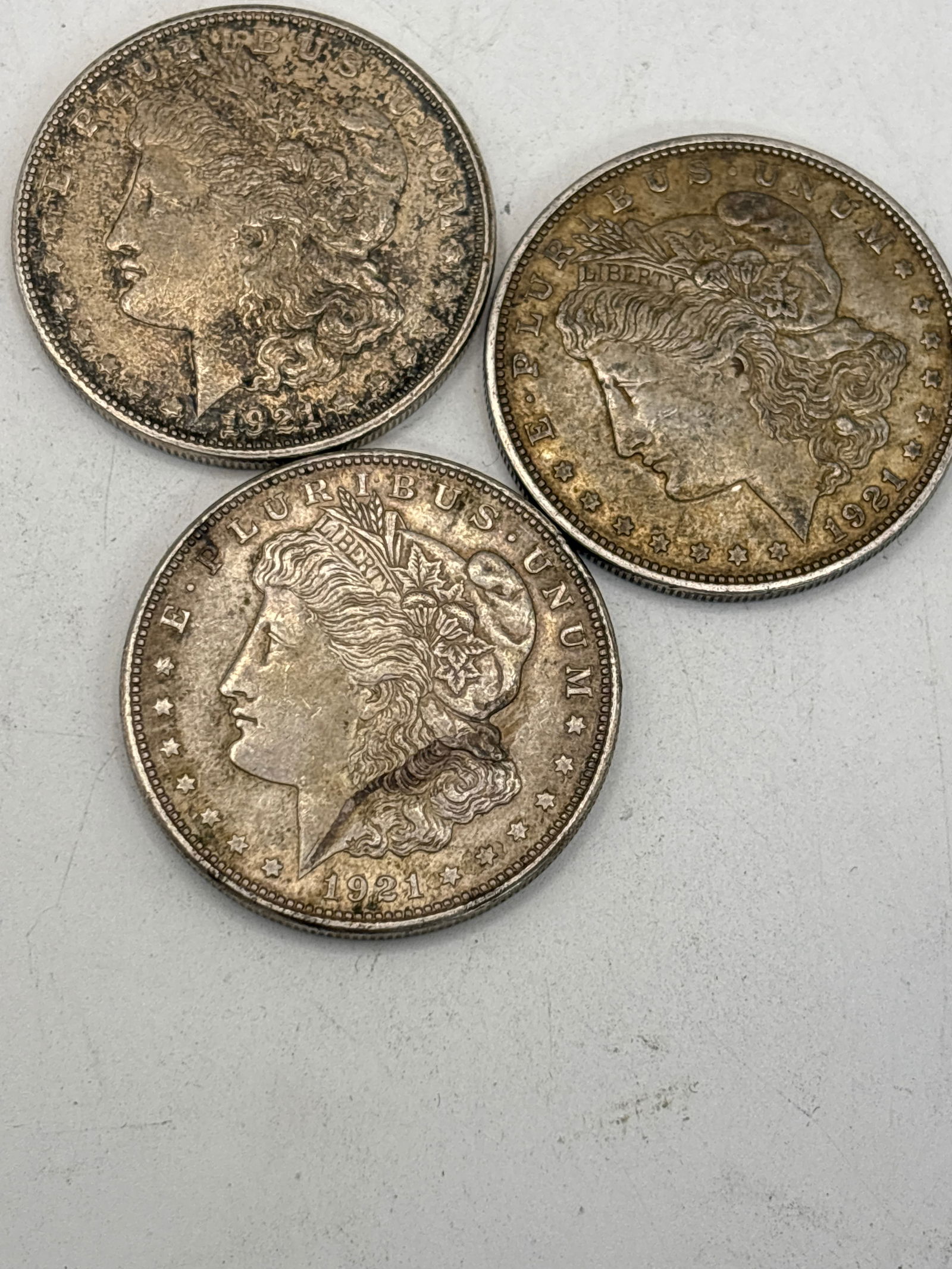 Three original dated 1921 Morgan American silver dollars, dirty (1 of 5)