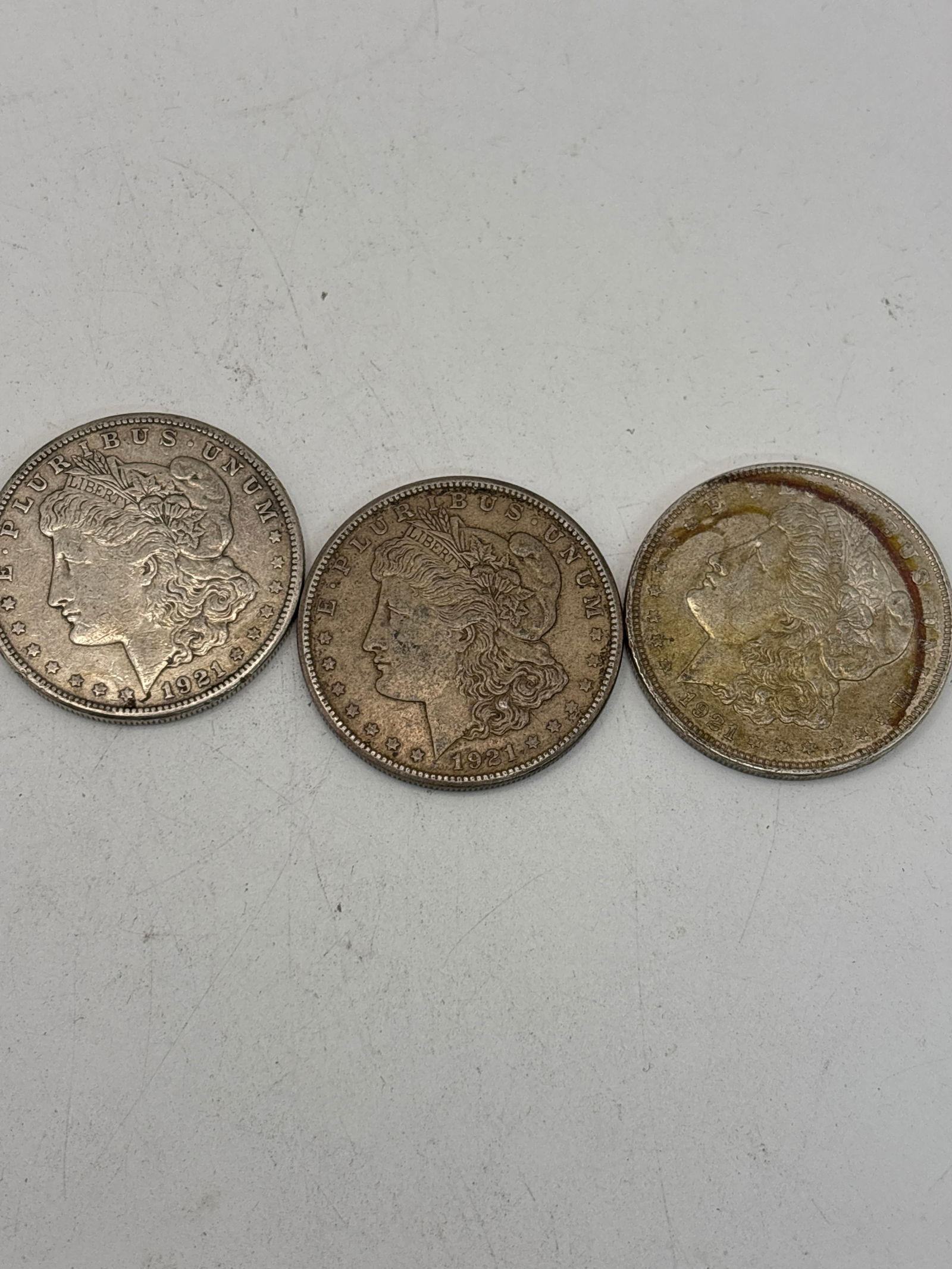 Three original 1921 dated Morgan American silver dollars, worn (1 of 5)