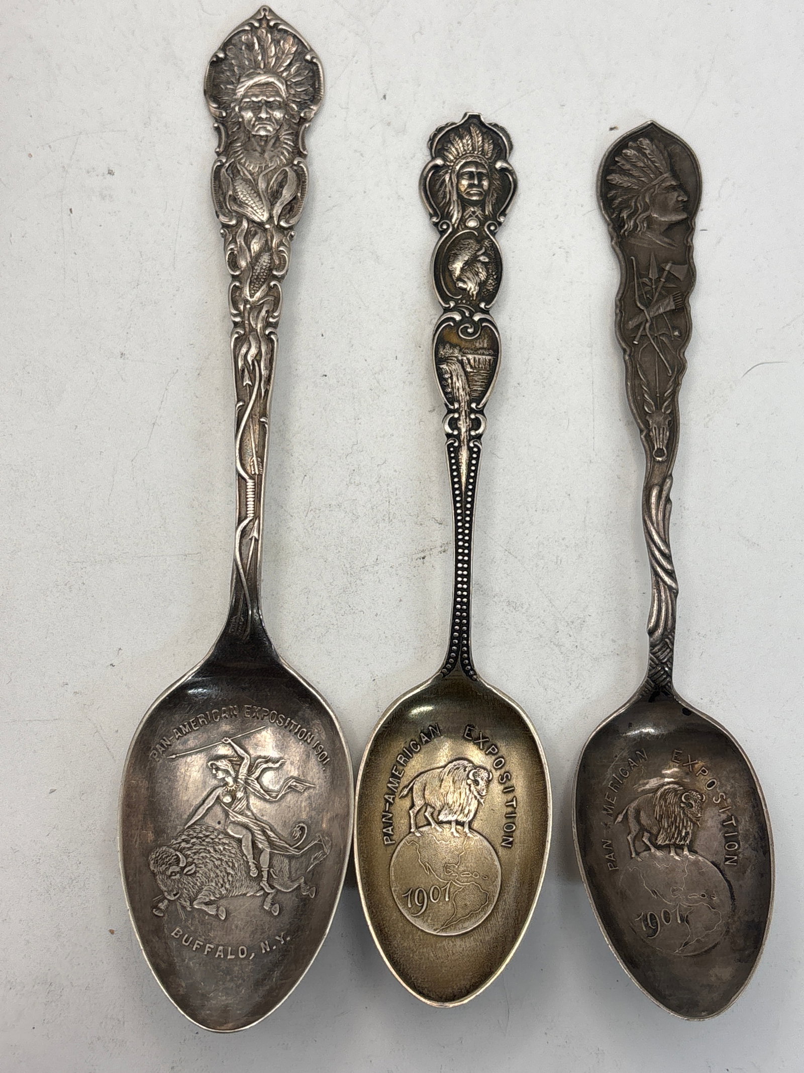 1991 Three Pan-American Exposition Buffalo sterling silver souvenir spoons; 56 grams: 1991 Three Pan-American Exposition Buffalo sterling silver souvenir spoons; 56 grams. A 5&7/8 inch native Indian handle & semi-nude riding a buffalo bowl end, a 5 inch with Indian & buffalo and a simi