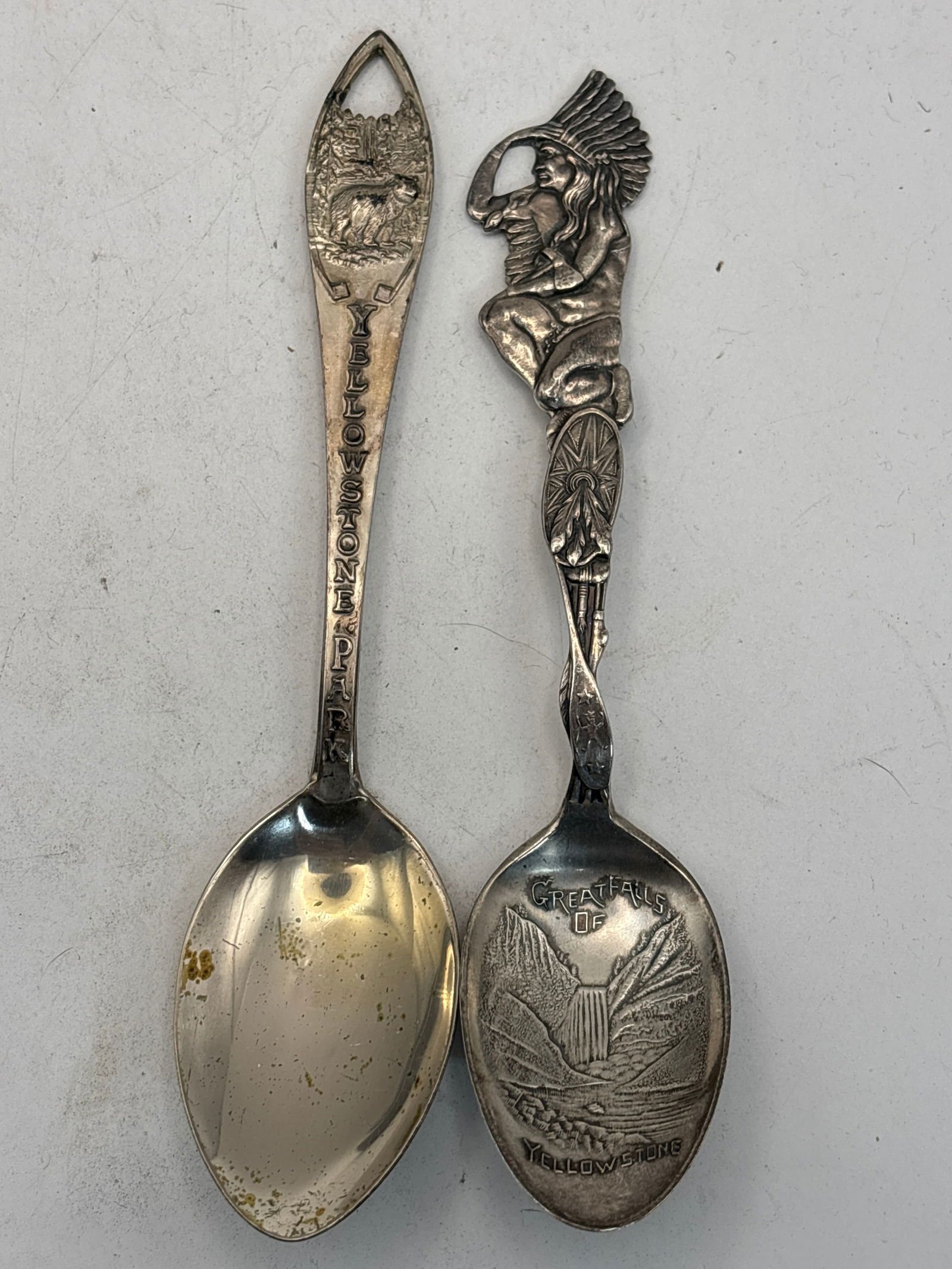 Two Yellowstone Sterling silver 5&1/4 inch souvenir spoons; 44 grams: Two Yellowstone Sterling silver 5&1/4 inch souvenir spoons; 44 grams.One with American Indian design & Great Falls of Yellowstone, other with bear design. Circulated used condition