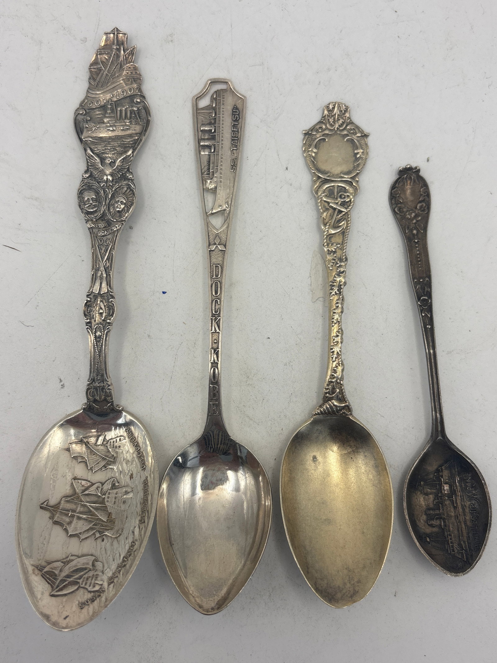 Four nautical related historical, ships,etc sterling silver spoons; 68 grams: Four nautical related historical, ships,etc sterling silver spoons; 68 grams. A 5&3/4 inch 1697-1907 Smith & Pocahontas ship motif spoon, 5 inch pierced through “S.S. Raisers” Dock Kobe, a4&3/