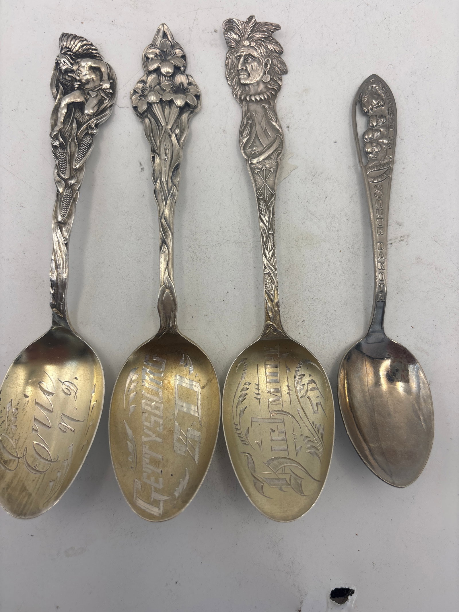 Four South & North Dakota sterling silver spoons; 48 grams: Four South & North Dakota sterling silver spoons; 48 grams. A 5 inch Highmore, S.D. With Native Indian, Gettysburg, S.D., Erie, N.D. With Native and a 4 inch Mt Rushmore( NOT STERLING).used condition