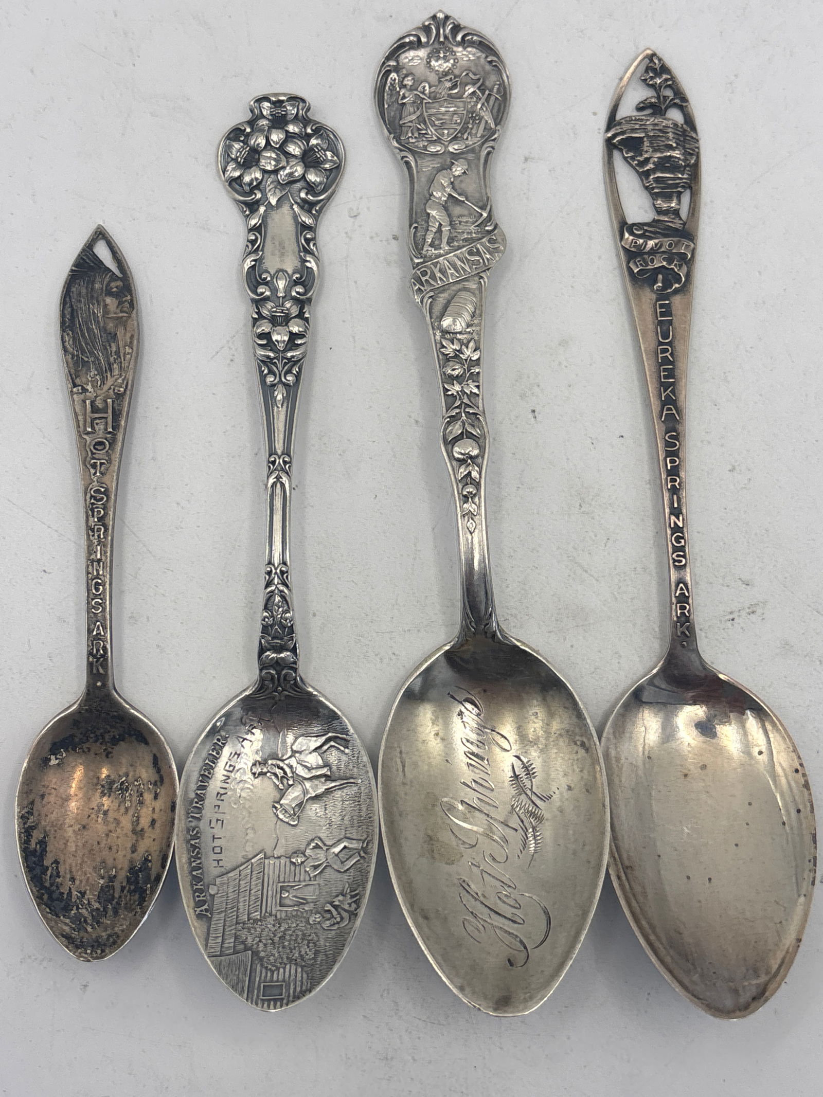 Four Arkansas sterling silver souvenir spoons;67 grams: Four Arkansas sterling silver souvenir spoons;67 grams. A 5&3/4 inch Hot Springs, a pierced through handle Eureka Springs, a 5&1/8 Arkansas Traveler Hot Springs and a 4&1/2 inch Hot Springs Native Ame