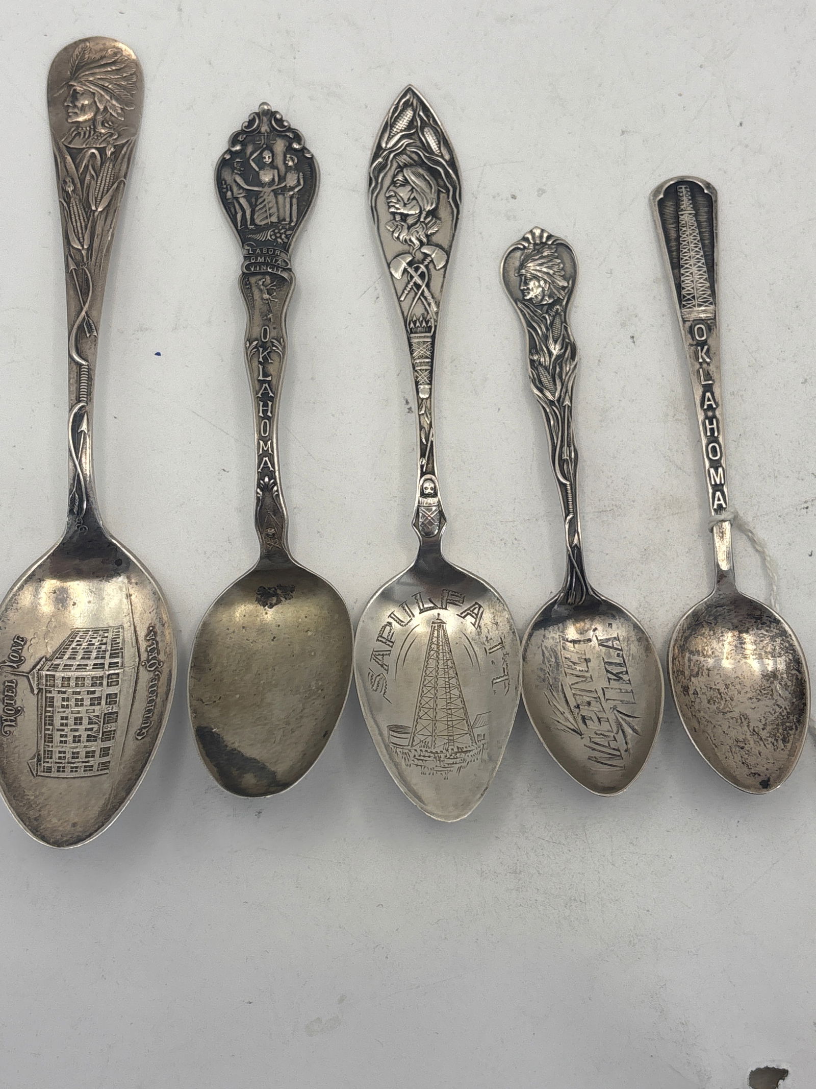 Five Oklahoma sterling silver souvenir spoons; 71 grams: Five Oklahoma sterling silver souvenir spoons; 71 grams. A 5 &3/4 inch Guthrie, Okla., oil rig Sapulpa, a 5 inch (worn), a4&1/2 Wagoner, Okla. and an oil rig one.Used