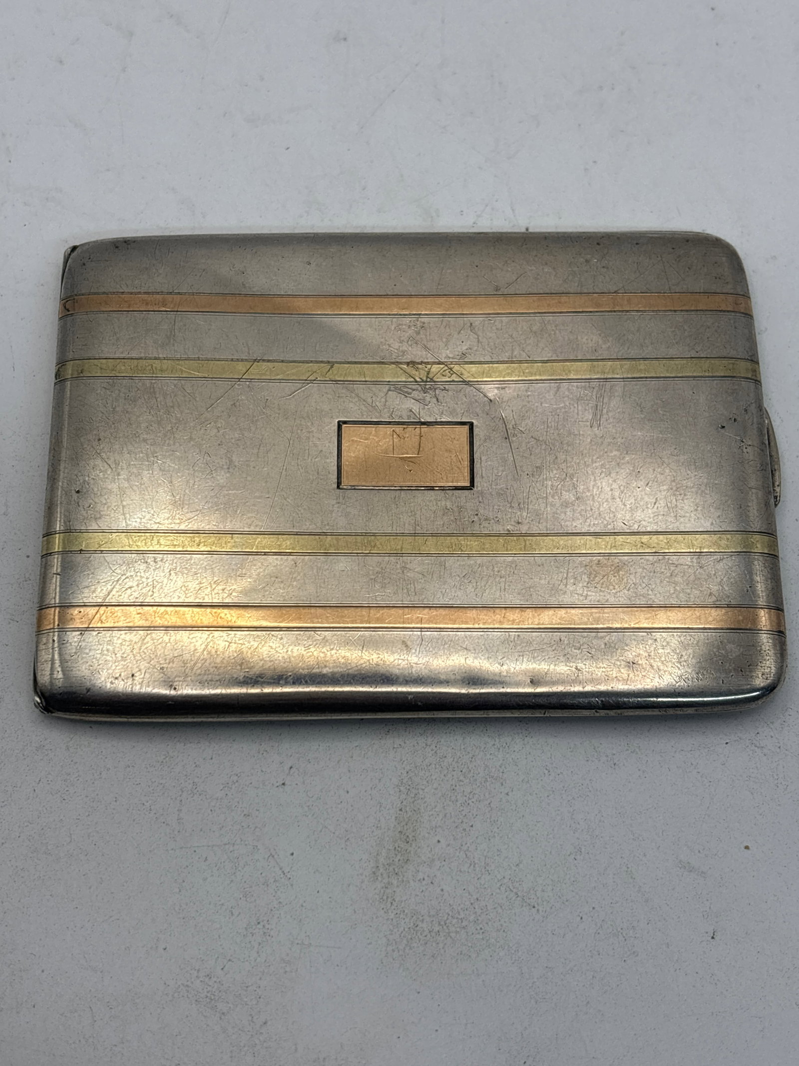 Art Deco 14 K, 18 K gold & Sterling silver 4 inch card case; 117 grams: Art Deco 14 K, 18 K gold & Sterling silver 4 inch card case; 117 grams. Hinged open case with alternating yellow gold & rose gold bands. No monogram.Very heavy.Good condition with light surface wear.