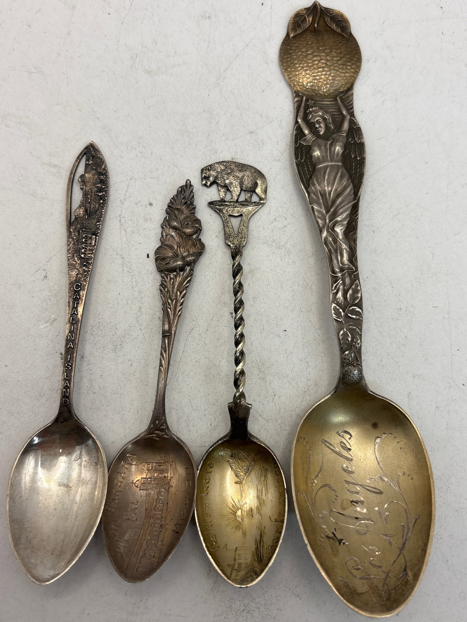 Four rare California sterling silver souvenir spoons; 55 grams: Four rare California sterling silver souvenir spoons; 55 grams. A rare 5&3/4 inch Los Angeles and three 3&3/4 inch.Good condition.