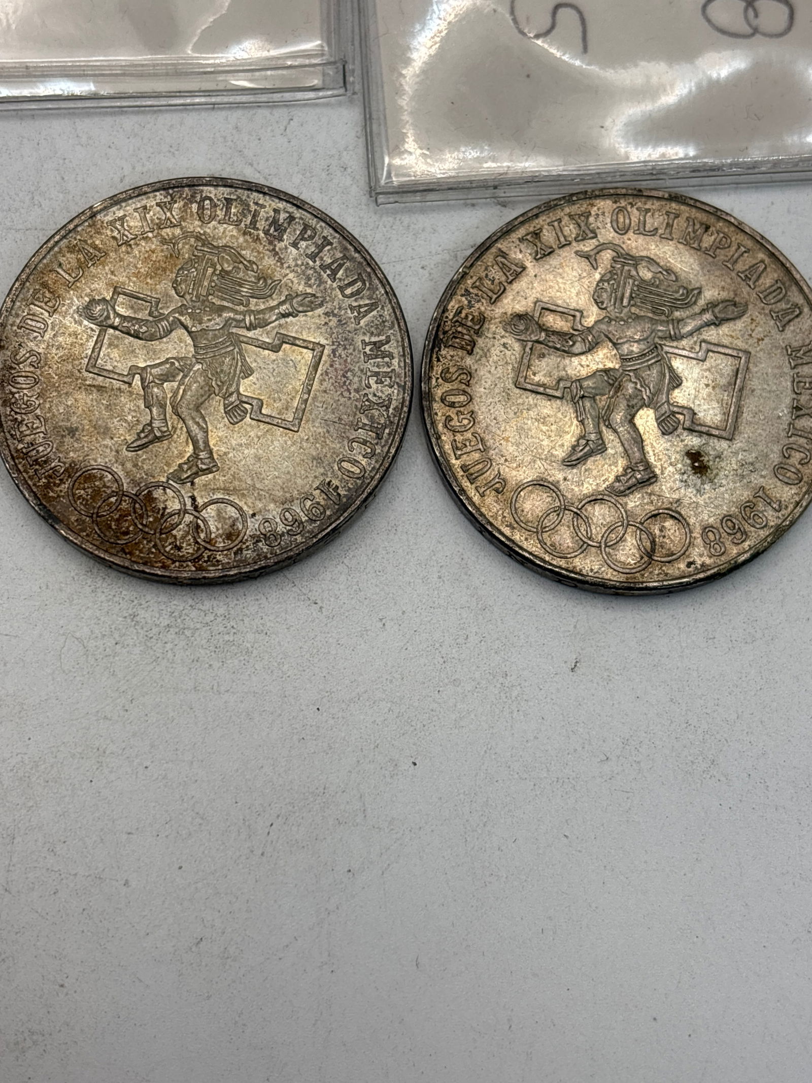 Two 1968 Mexico XIX Olympic Games 25 Pesos silver Coins: 1968 Mexico XIX Olympic Games 25 Pesos silver coin. The coin was minted to commemorate the Summer Olympics held in Mexico City in 1968. The reverse side, shown in the image, depicts an Aztec ball play