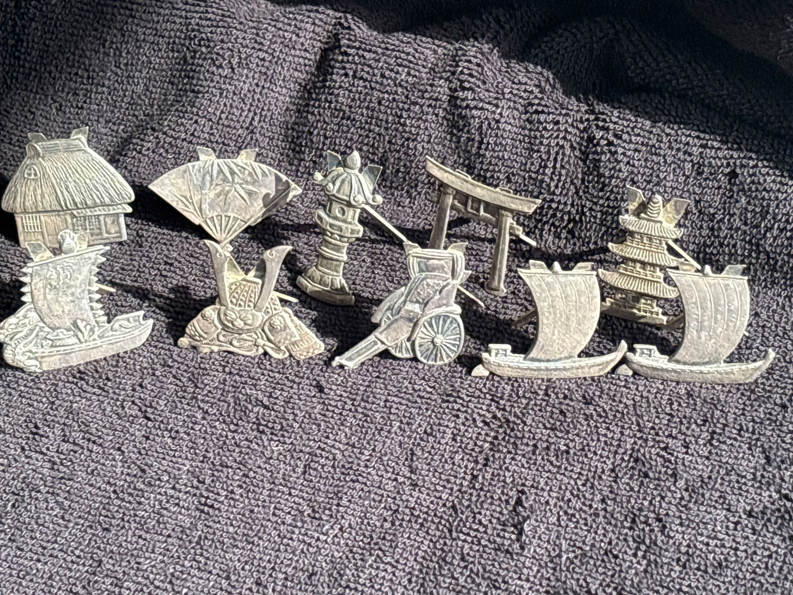 Ten assorted shape Japanese ornaments 950 sterling silver; 32 grams: Ten assorted shape Japanese ornaments 950 sterling silver; 32 grams. Various sizes. All marked 950 sterling.