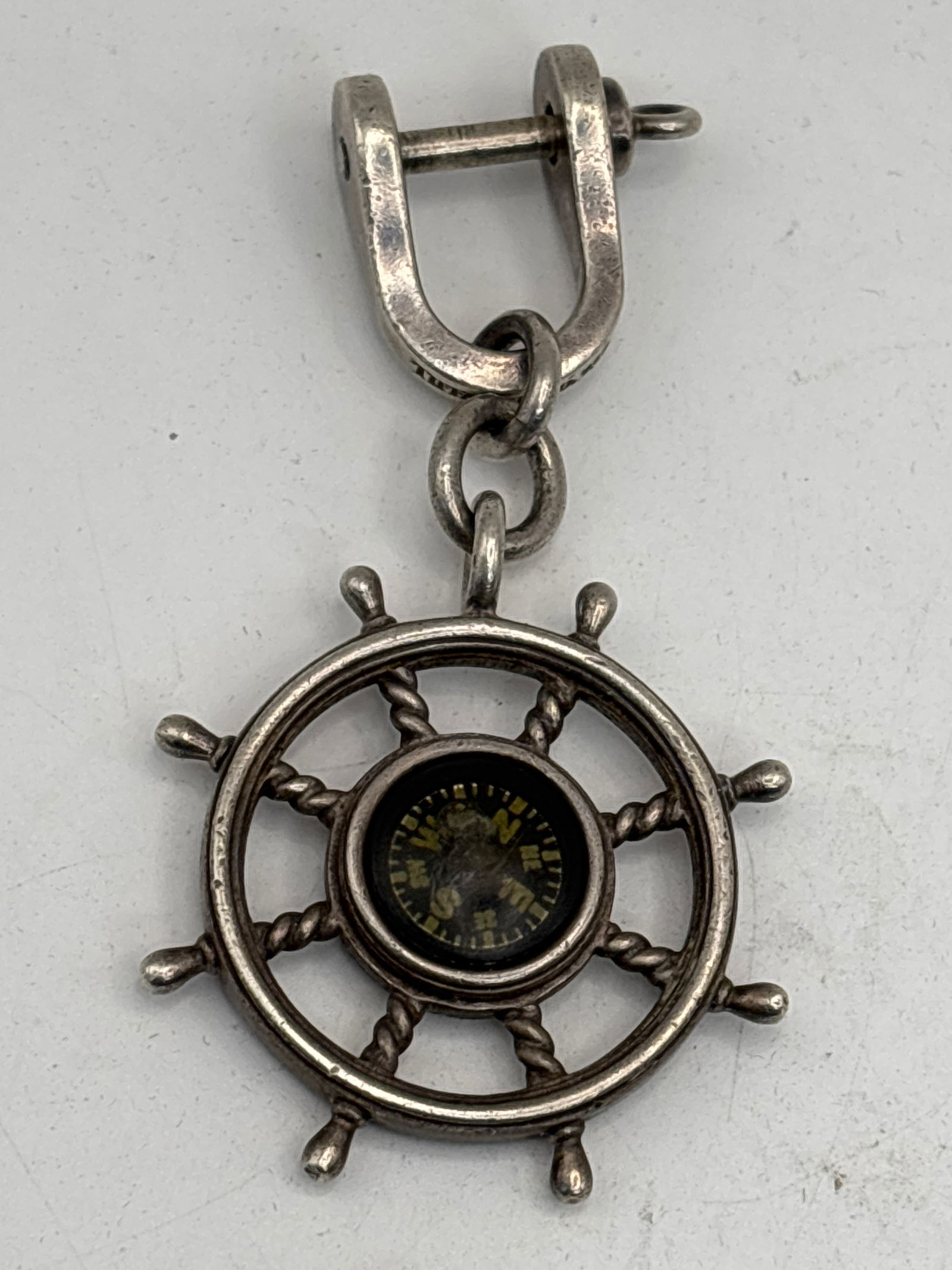 Tiffany & Co. 925 sterling silver 3 inch ship wheel compass key chain; 38 grams: Tiffany & Co. 925 sterling silver 3 inch ship wheel compass key chain; 38 grams. Tiffany & Co. sterling silver ship wheel compass keychain or key fob. This discontinued nautical accessory features a f