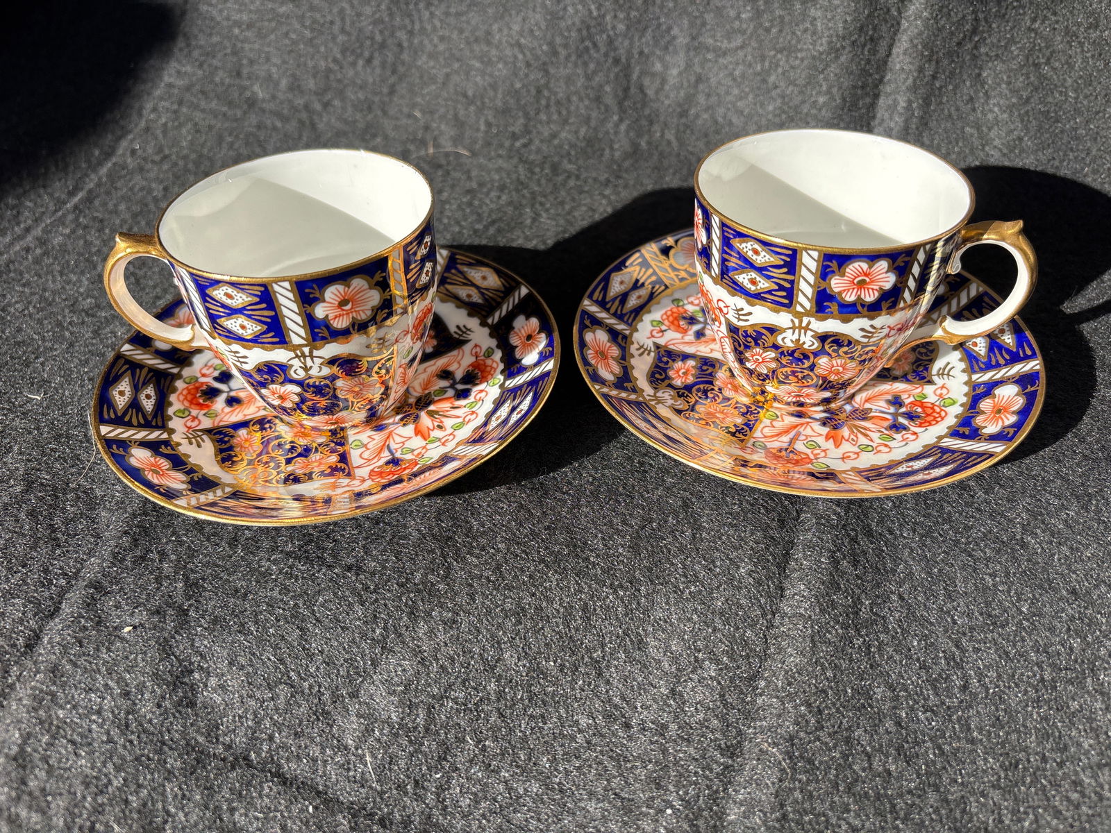Shaped Pair Royal Crown Derby "Old Imari" pattern (2451) Demi cups w/saucers: Pair Royal Crown Derby "Traditional Imari" or "Old Imari" pattern (2451) demitasse cups and saucers. The pattern, one of the company's most popular designs, was introduced in the late 19th century. Th