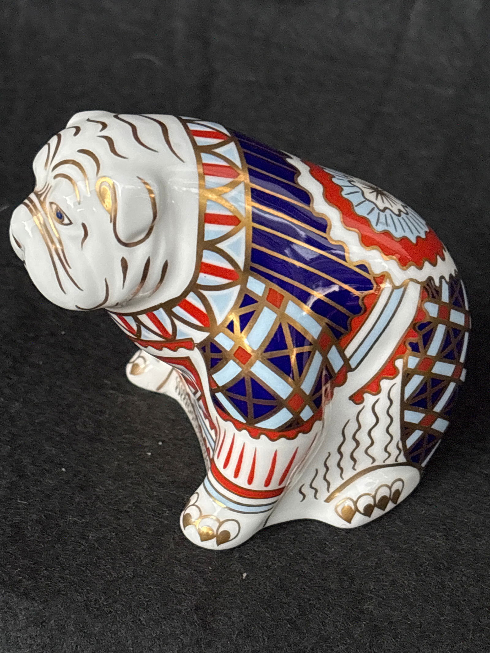 Royal Crown Derby Imari Bulldog 4 inch paperweight: Royal Crown Derby Imari Bulldog paperweight. It is made of fine bone china and embellished with 22-carat gold gilding. The design features a seated bulldog decorated with intricate geometric and flora