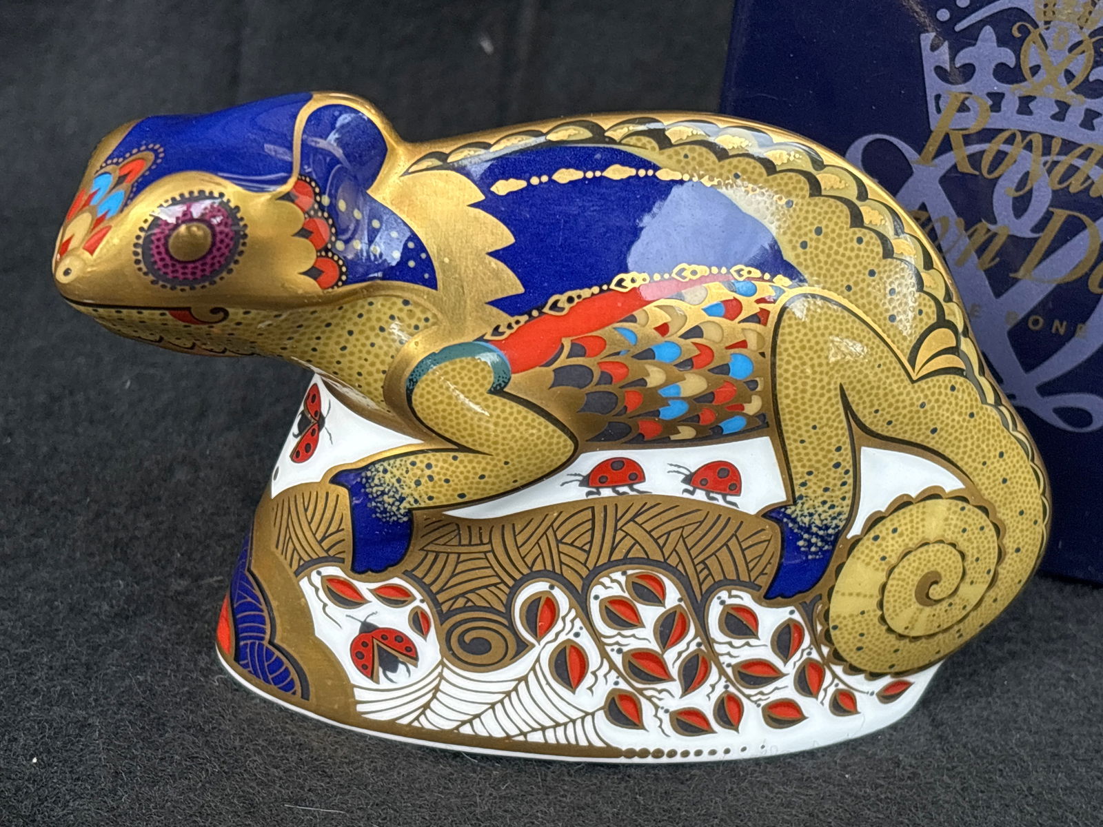 2003 Uncommon Royal Crown Derby "Chameleon"5&3/8 inch paperweight: Gold stopper. With box.Royal Crown Derby "Chameleon" paperweight. It is made of bone china and hand-painted in the Imari style with lavish 22-carat gold gilding. The piece was produced in 2003 and fea