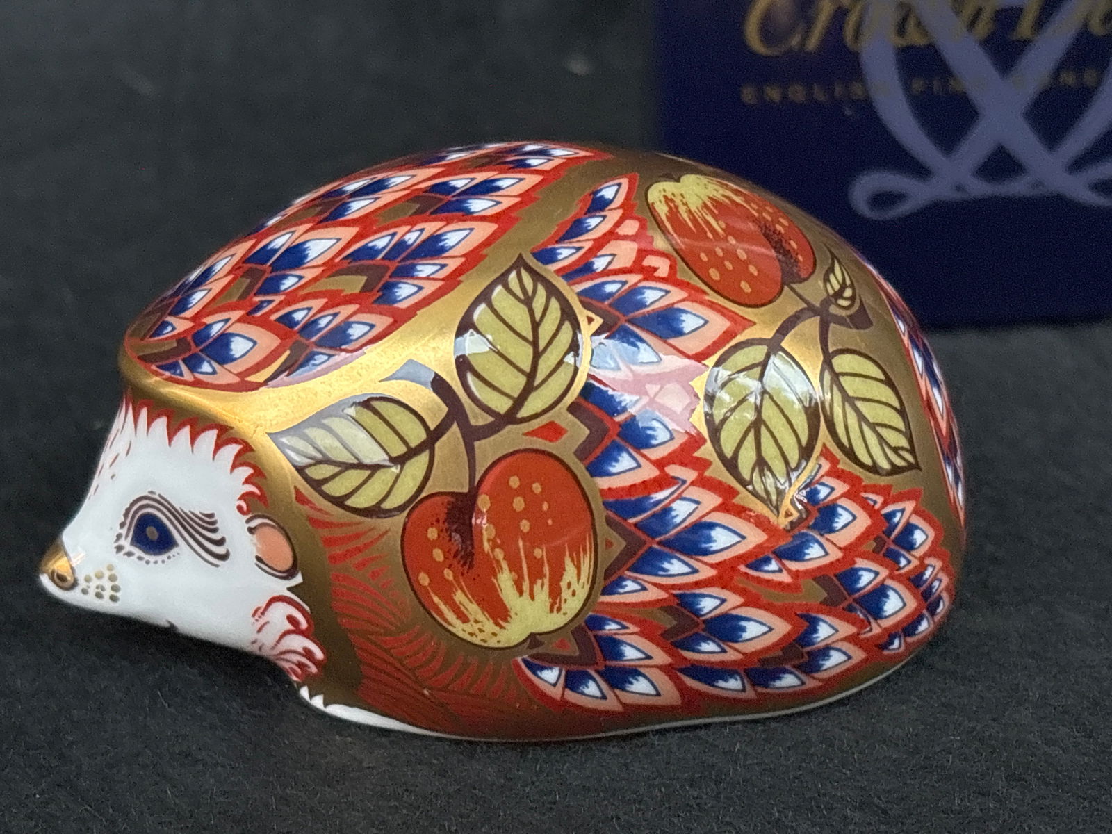 Artist signed exclusive Orchard Hedgehog Royal Crown Derby 3&1/2 inch paperweight: Gold stopper. With box.Royal Crown Derby Orchard Hedgehog paperweight, featuring the traditional Imari pattern with rich colors and 22-carat gold highlights. Manufacturer: Royal Crown Derby, a prestig
