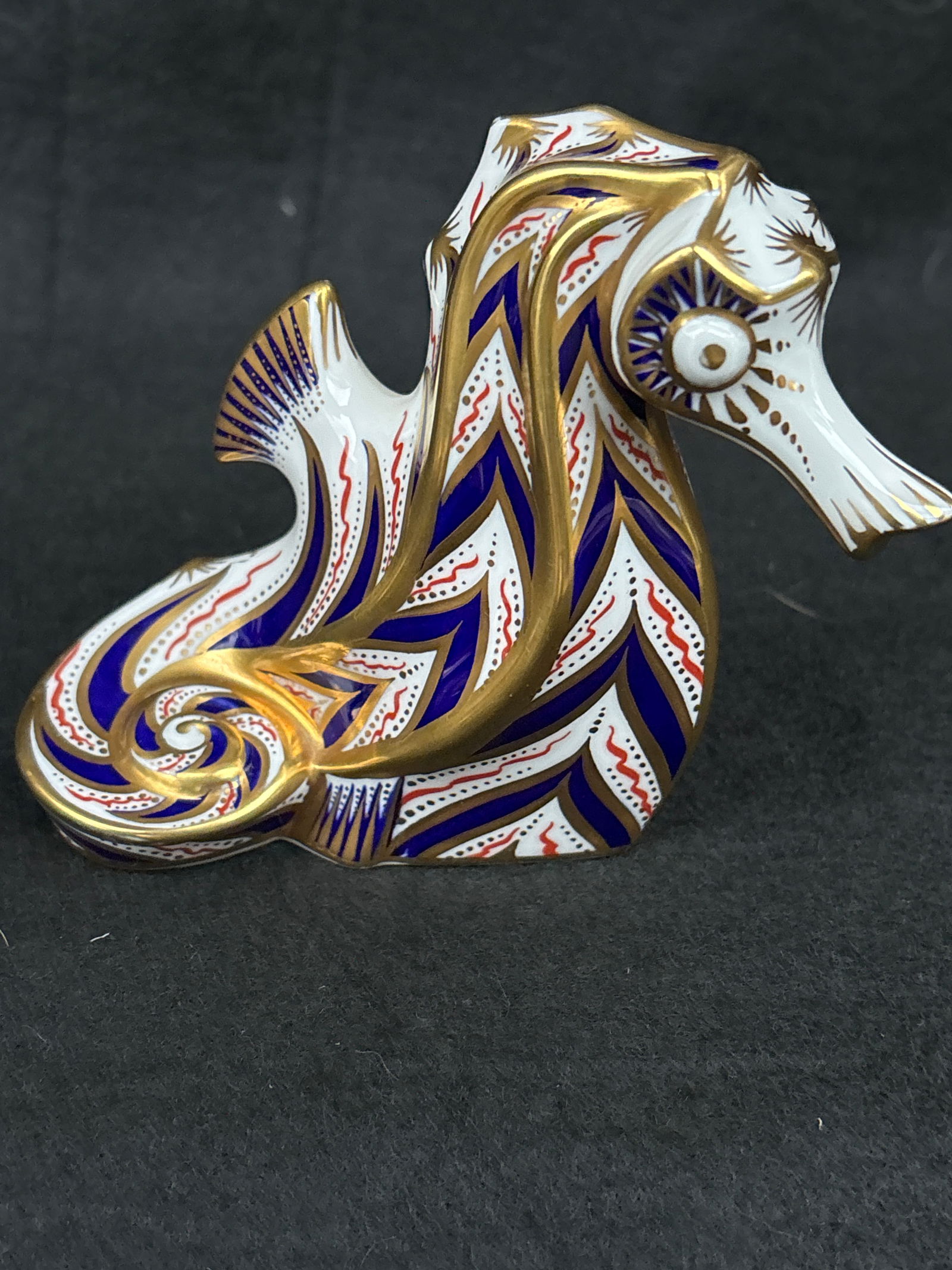Solid gold band Seahorse Royal Crown Derby 4 inch paperweight: Silver stopper. No box. Solid gold band Seahorse Royal Crown Derby 4 inch paperweight.It is made of bone china. It features an intricate, hand-decorated Imari pattern with cobalt blue and gilt accents