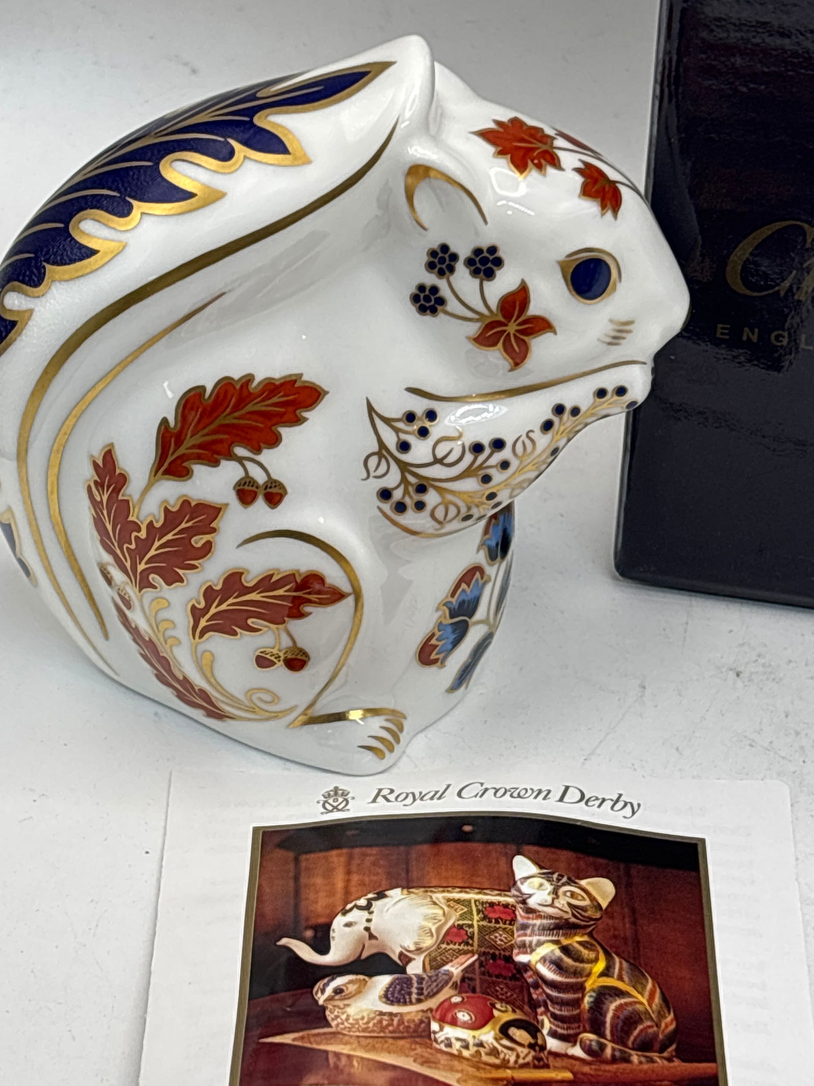 Autumn Squirrel Royal Crown Derby 3&3/4 inch paperweight: Silver stopper. With box.It features the traditional Imari pattern in rich orange, red, and cobalt blue, with extensive 22-carat gold gilding.Each paperweight is hand-decorated, making every piece uni
