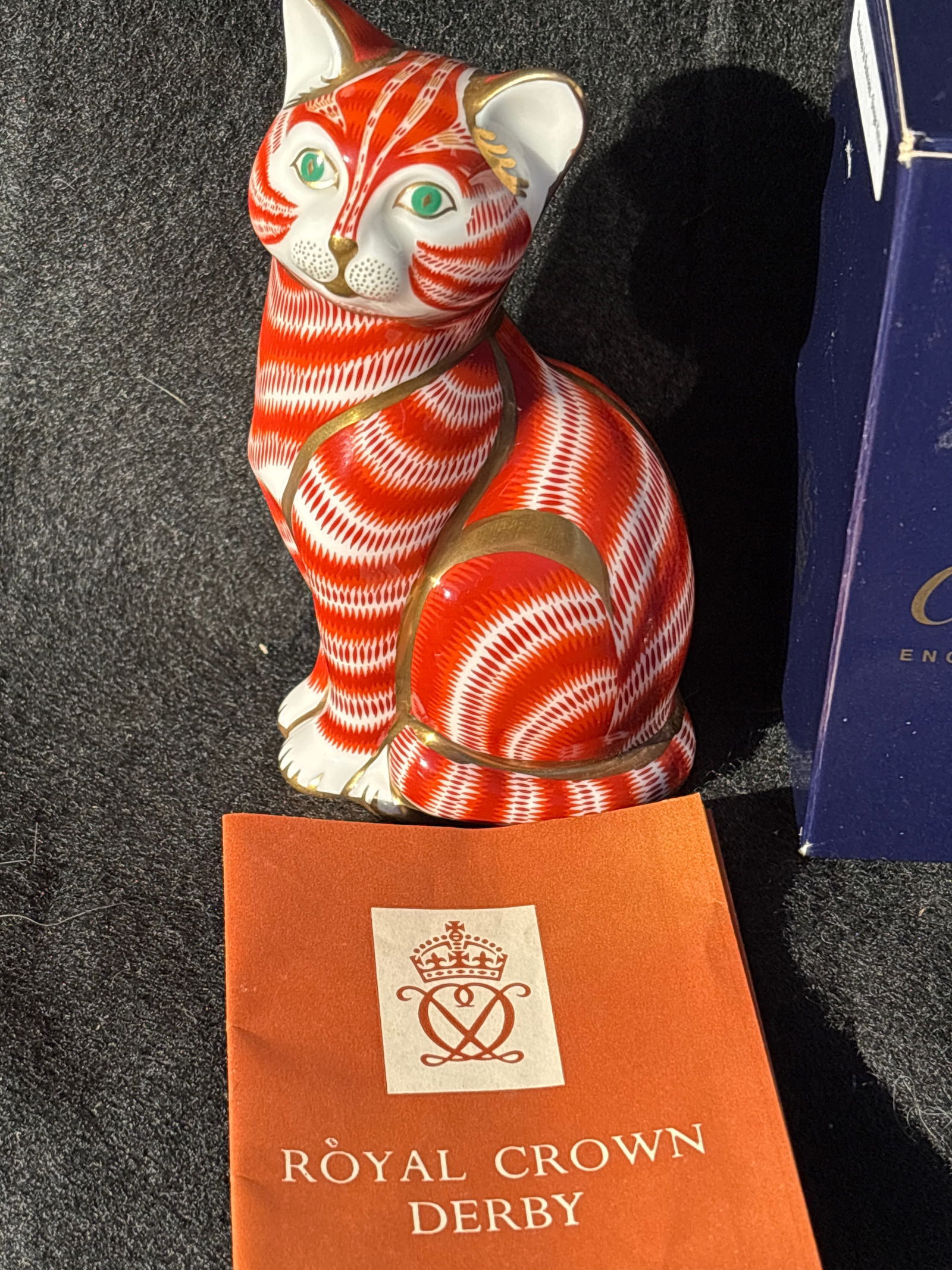 Royal Crown Derby "Ginger Tom Cat" 5 inch paperweight: Gold stopper. With box.Royal Crown Derby "Ginger Tom Cat" paperweight, known for its distinctive orange/red and white Imari pattern. Stands approximately 5 inches tall.Features a vibrant auburn, gold,