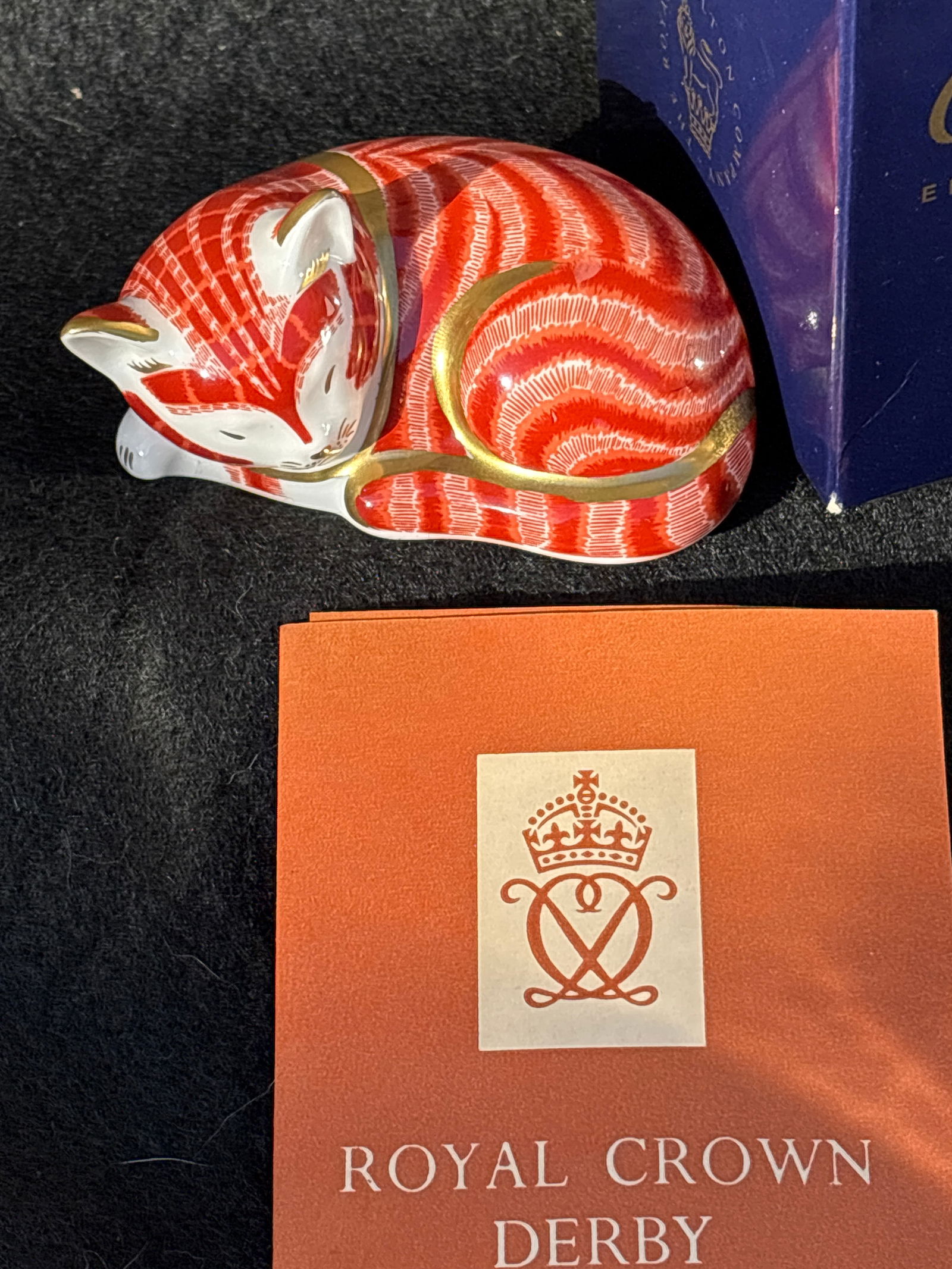 Royal Crown Derby ‘Sleeping Ginger Kitten’ 3 inch paperweight: Gold stopper. With box.Royal Crown Derby "Sleeping Ginger Kitten” paperweight, known for its distinctive orange/red and white Imari pattern. Stands approximately 5 inches tall.Features a vibrant