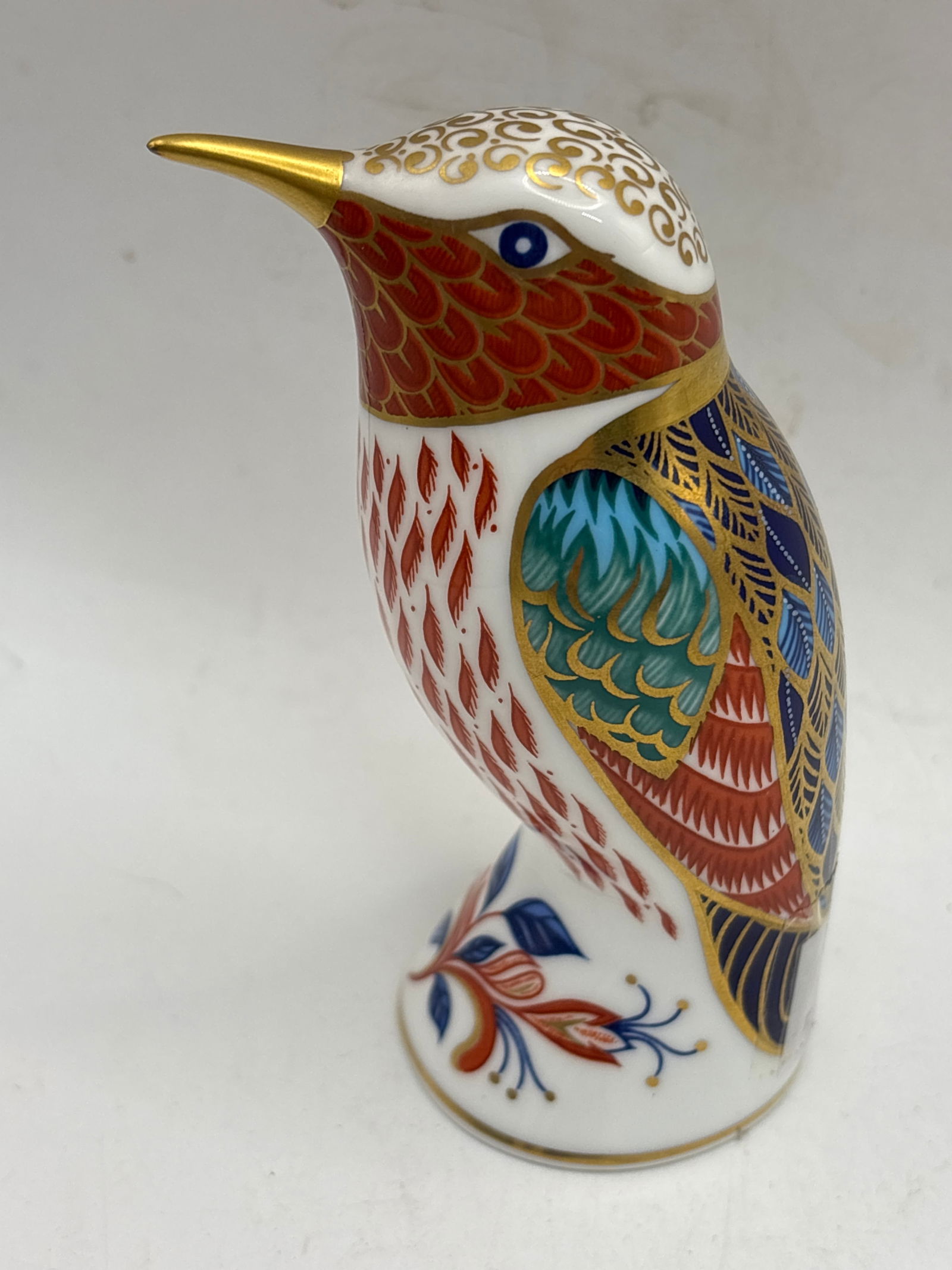 Hummingbird Royal Crown Derby 4 inch paperweight: No box. Gold stopper.Hummingbird Royal Crown Derby 4 inch paperweight.The piece is made of bone china, decorated in the traditional Imari style with reds, greens, and blues, and enhanced with 22-carat