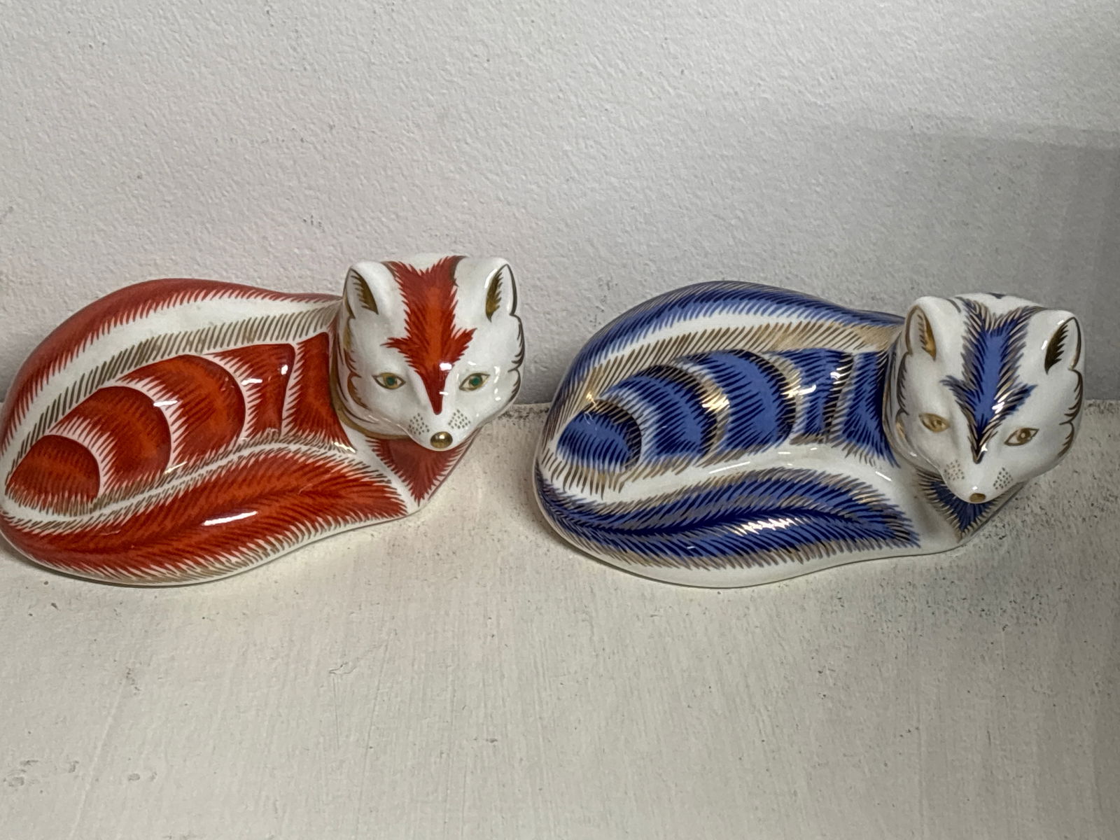 Blue fox & a red fox Royal Crown Derby paperweights: second quality.No box. Silver stopper.One red & one blue.