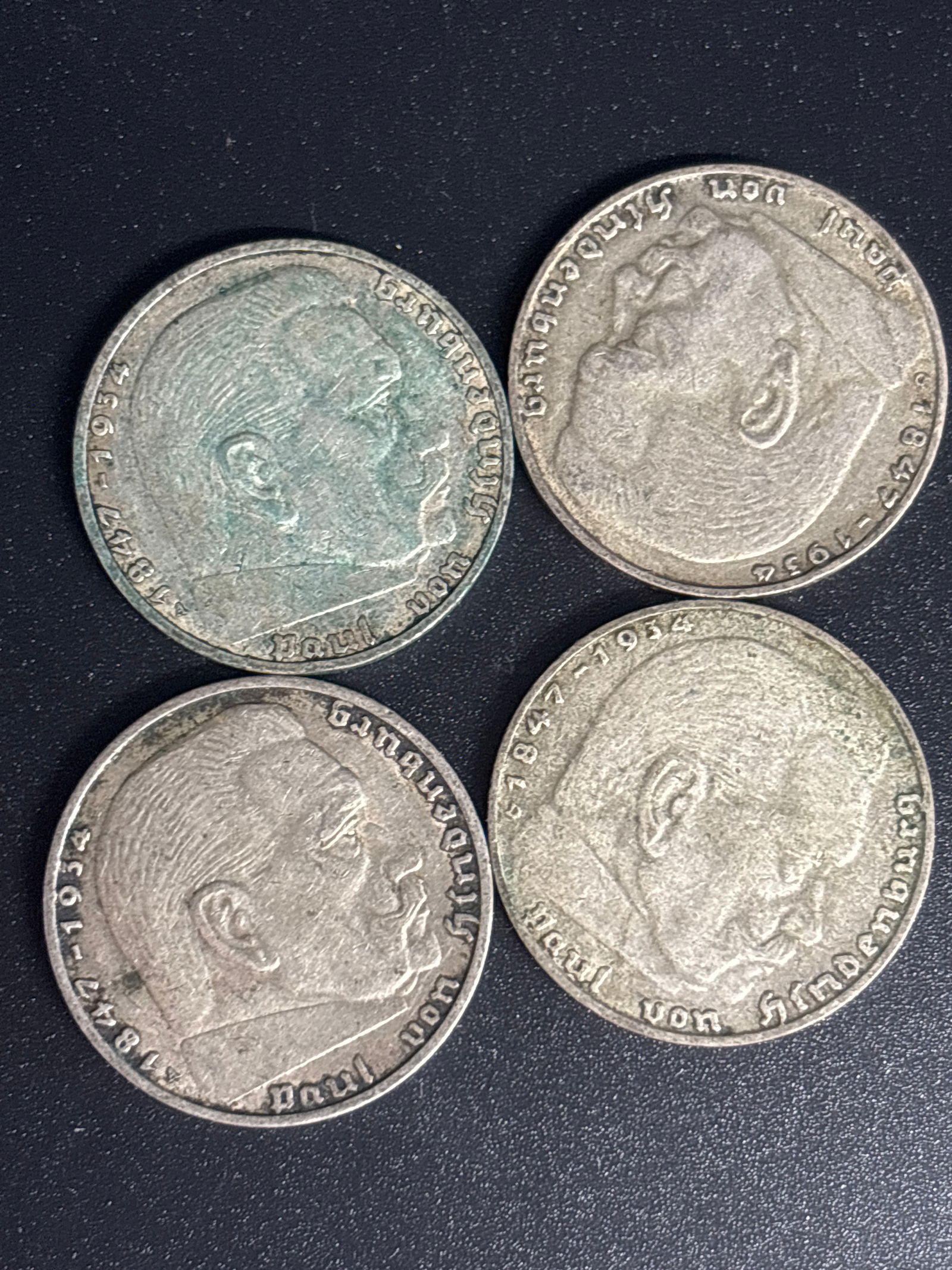 Four 1937 German 2 Reichsmark coin from 1938 Third Reich period: Four German 2 Reichsmark coin from 1938, issued during the Third Reich period. Material: The coin is composed of silver, typically 62.5%. Design: The obverse features the German national eagle