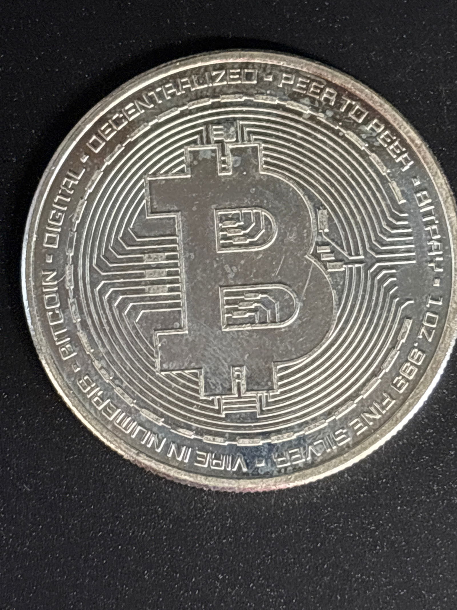 1 Troy Ounce .999 fine silver Bitcoin logo commemorative coin: a physical commemorative coin designed to represent Bitcoin, commonly marketed as a collectible token rather than legal tender. Material: with higher-end versions are made of solid .999 fine silver.