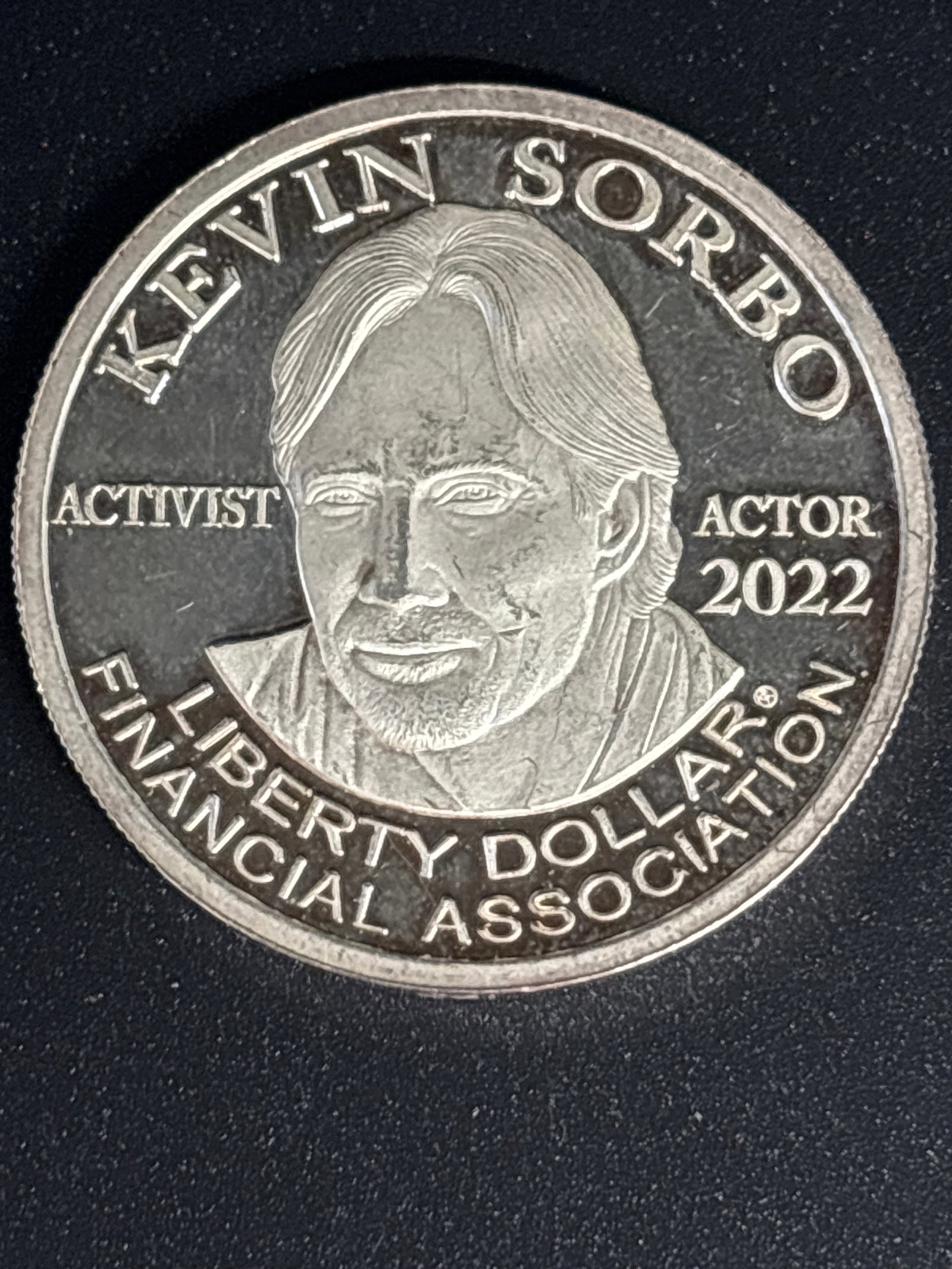 1 Troy Ounce .999 fine silver 2022 Kevin Sorbo commemorative coin: 2022 1oz silver Liberty Dollar issued by the Liberty Dollar Financial Association (LDFA), featuring actor and activist Kevin Sorbo.Key Details of the CoinSubject: Kevin Sorbo, labeled as "Activist" an