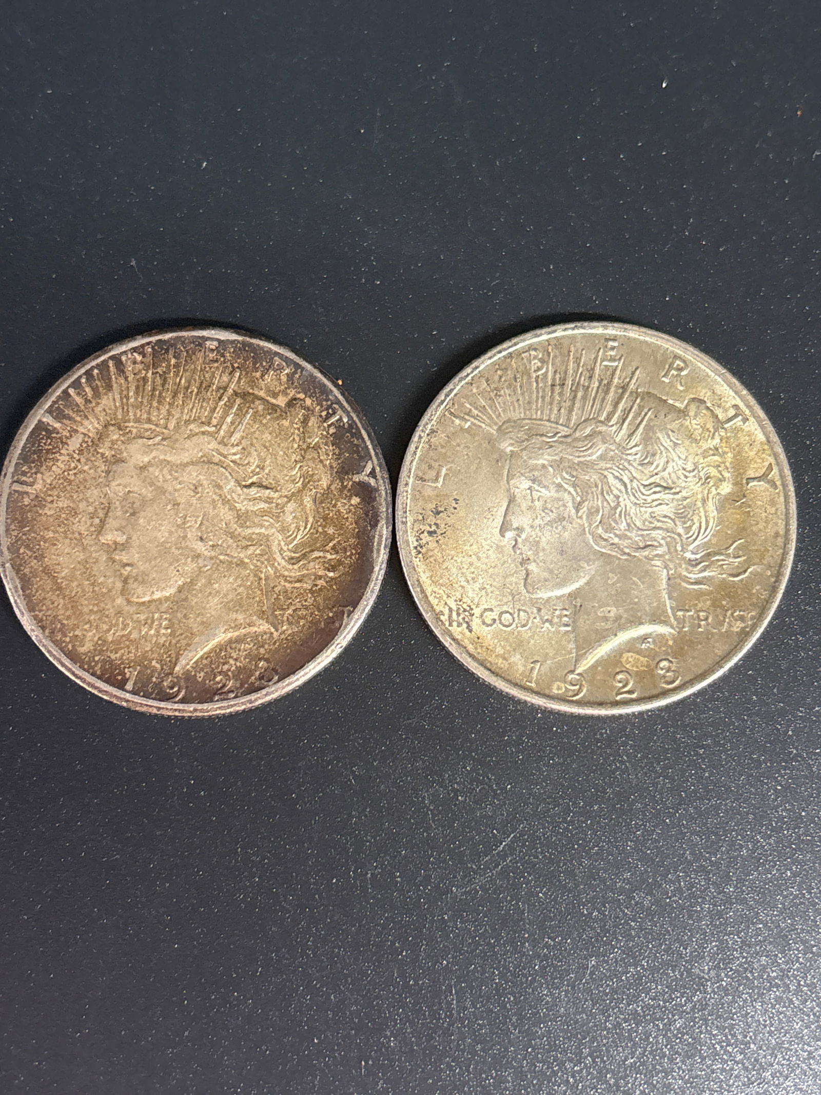 Two dated 1923 Peace American silver dollars: two 1923 United States Peace Silver Dollar. Material: Composed of 90% silver and 10% copper, with a net weight of approximately \(0.77344\) troy ounces of pure silver. Design: Designed by Anthony de F