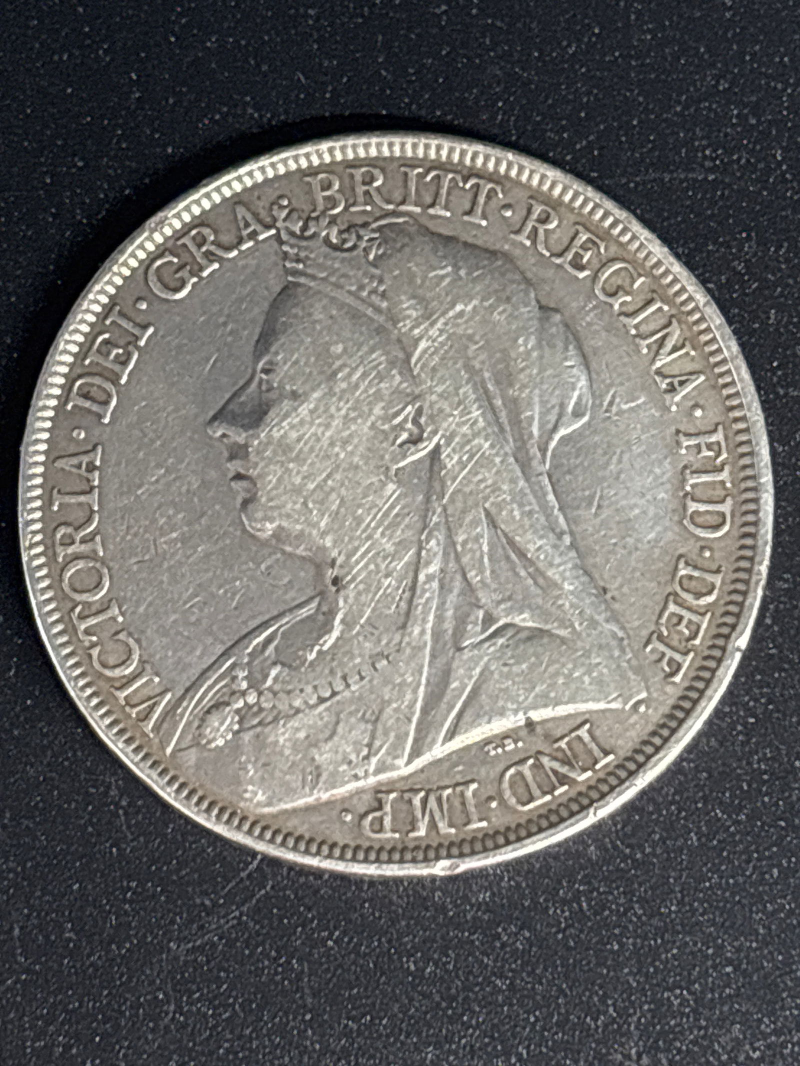Rare 1898 United Kingdom silver crown featuring Queen Victoria: 1898 United Kingdom silver crown featuring Queen Victoria, a collectible coin depicting St. George slaying the dragon on the reverse. Metal Content: .925 sterling silver.Weight: Approximately 28.28