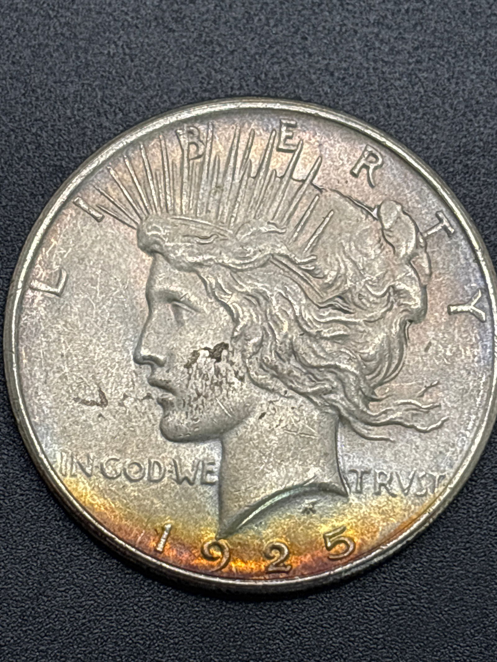 1925 Peace American silver one dollar coin; light toning (1 of 3)