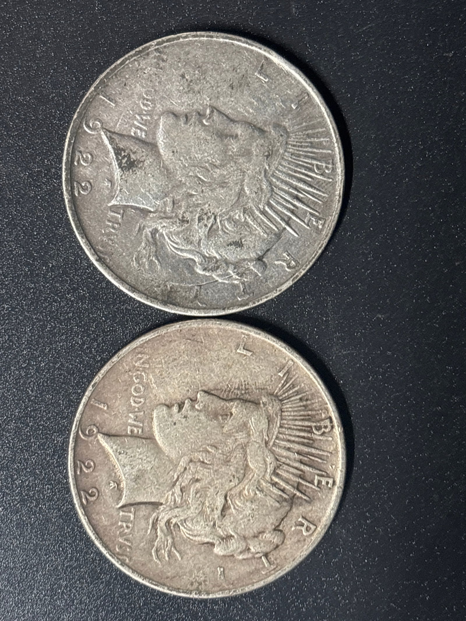 Two 1922 Peace United States Silver Dollar coin: Two 1922 Peace Silver Dollar, a U.S. coin minted to commemorate the end of World War I. Composition: It is made of 90% silver and 10% copper, containing approximately 0.77344 troy ounces of pure silve