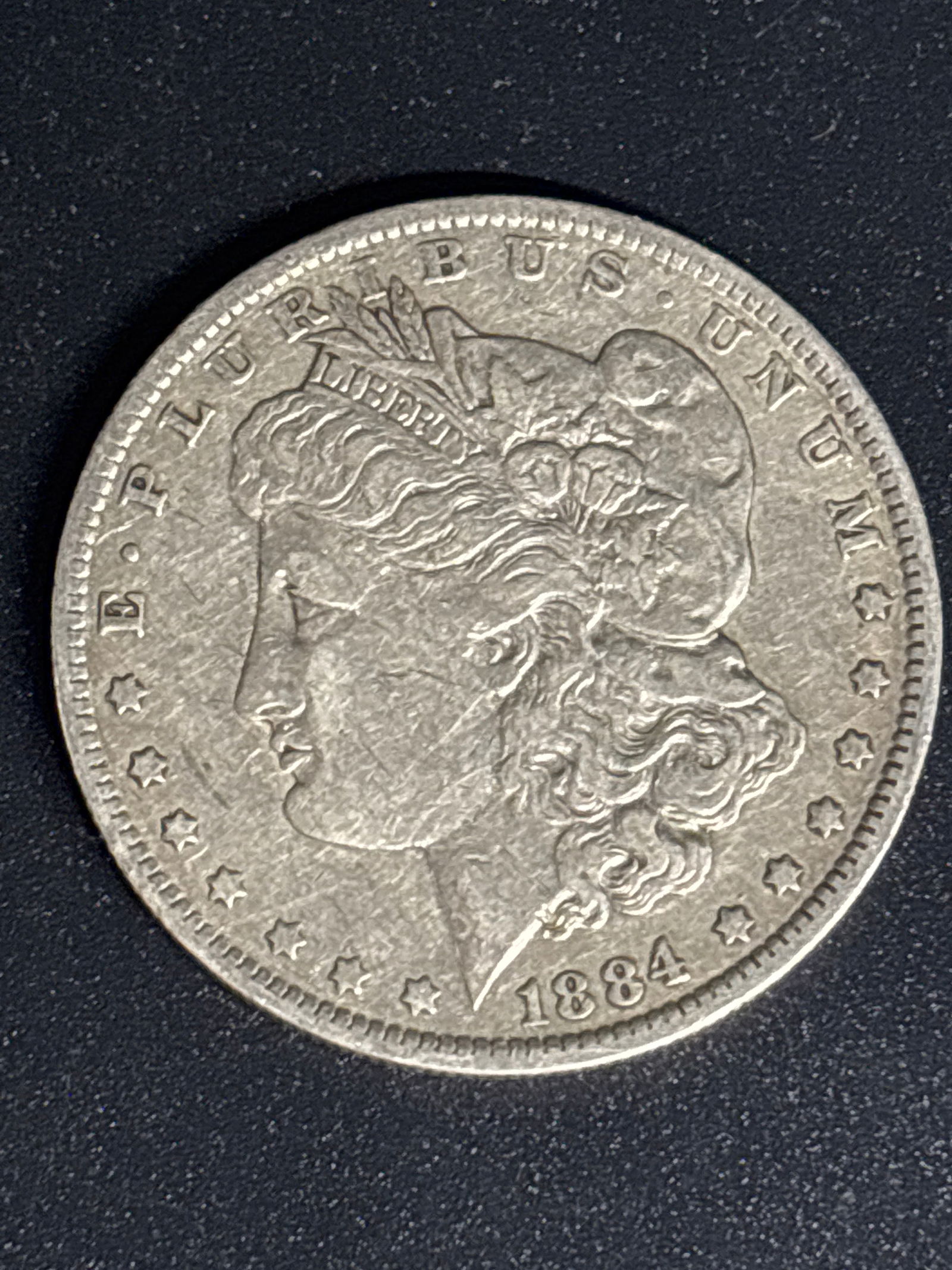 American Morgan Silver Dollar minted in 1884: American Morgan Silver Dollar minted in 1884. Composition: Contains 90% silver and 10% copper, with a total weight of 26.73 grams. Designer: Designed by United States Mint Assistant Engraver George T.