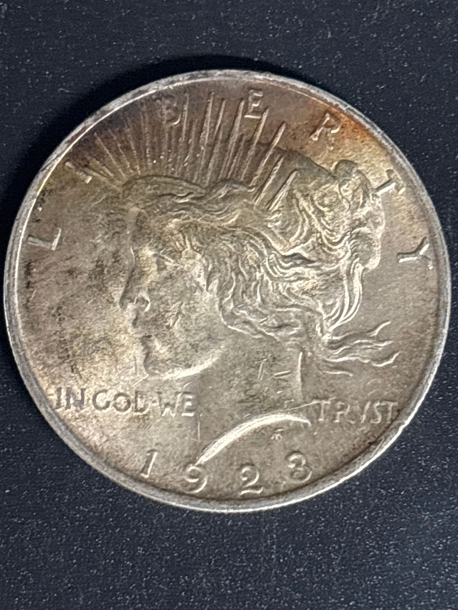 Original 1923 Peace American Silver Dollar: 1923 Peace Silver Dollar, a U.S. coin minted to commemorate the end of World War I. Specifications: It is composed of 90% silver and 10% copper, weighing approximately 26.73 grams. Design: The coin fe
