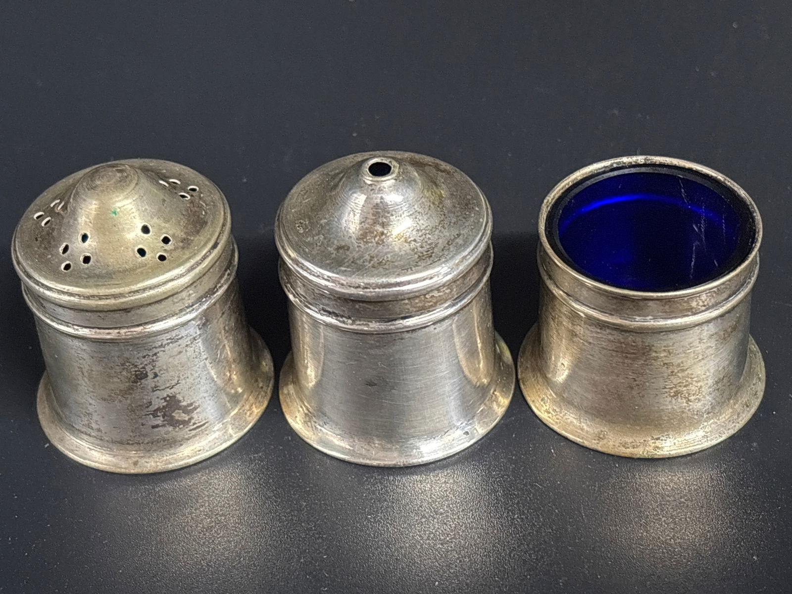 English sterling silver condiment or "cruet" set;,54 grams silver: English sterling silver condiment or "cruet" set, likely manufactured in Sheffield. These sets typically consist of three pieces: a salt shaker, a pepper shaker, and a mustard pot with a distinctive c