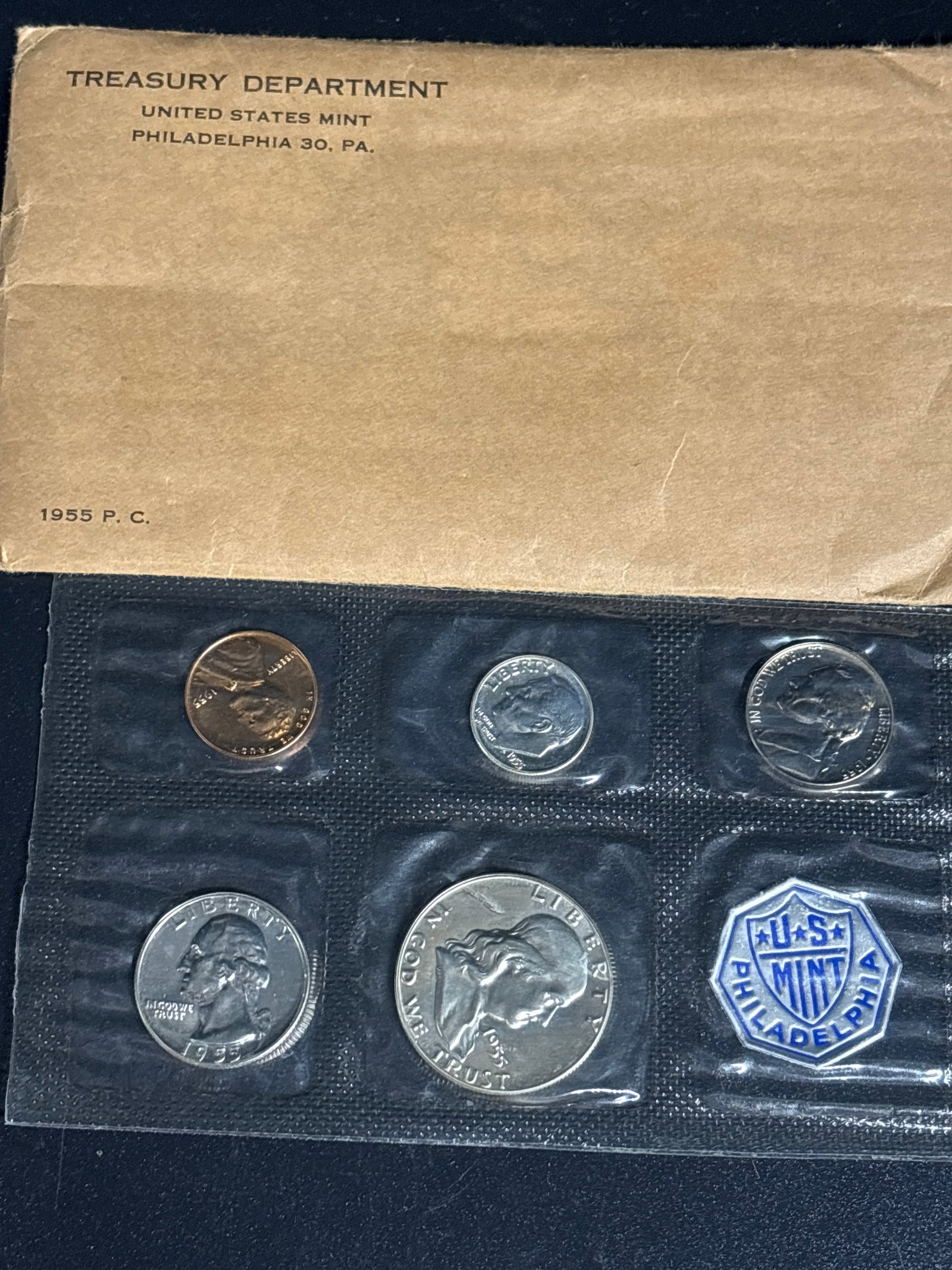 1955 United States Mint silver Proof set: 1955 United States Mint Proof Set in its original flat-pack cellophane packaging. These sets were specially produced by the Philadelphia Mint for collectors and feature coins with mirror-like backgrou