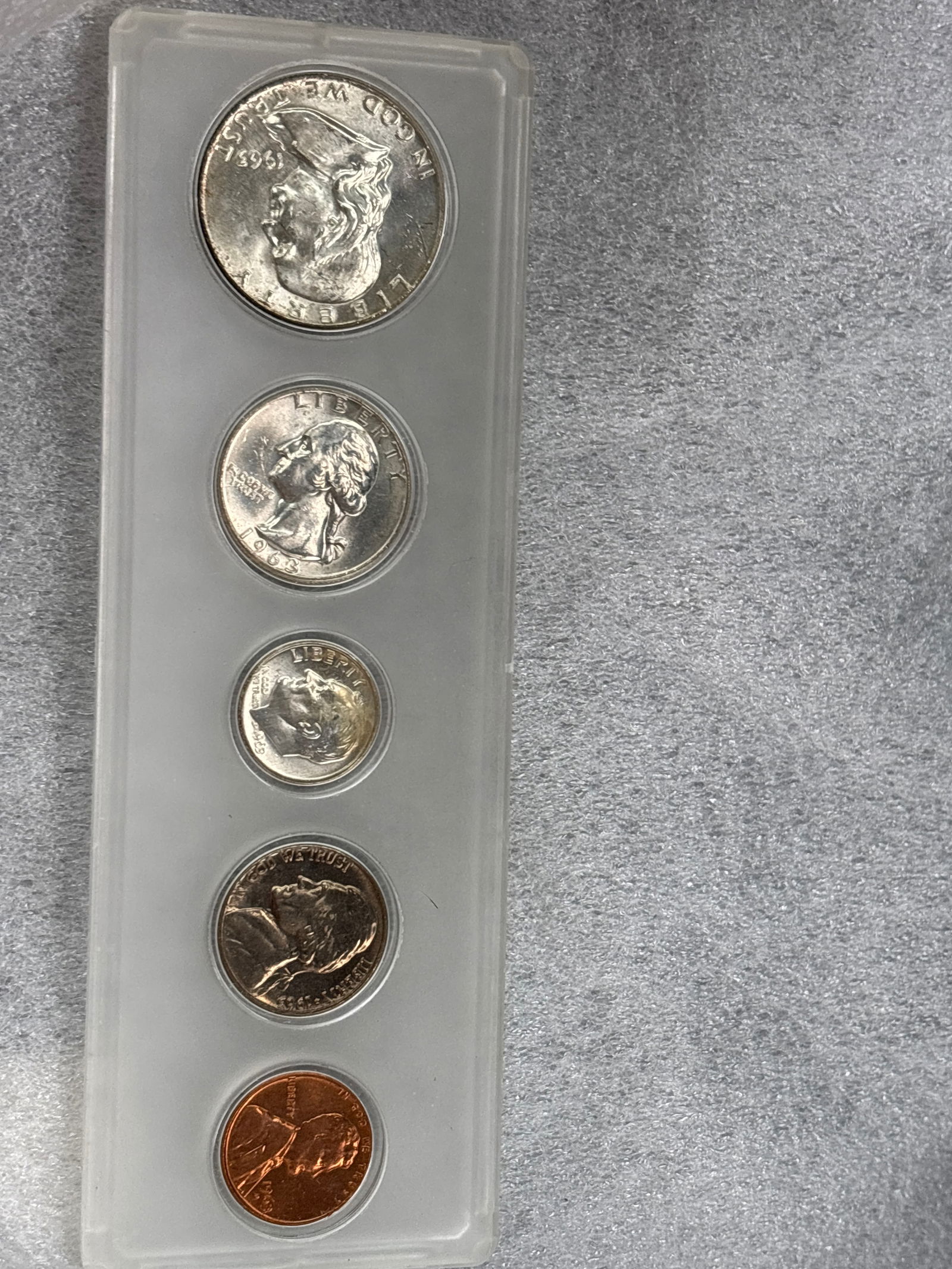 Five coin 1963 Franklin silver United States Proof Set: 1963 Kennedy United States Proof Set packaged in plastic holder, containing a Franklin half dollar, Washington quarter, Roosevelt dime, Jefferson nickel, and Lincoln cent. Silver Content: The half dol