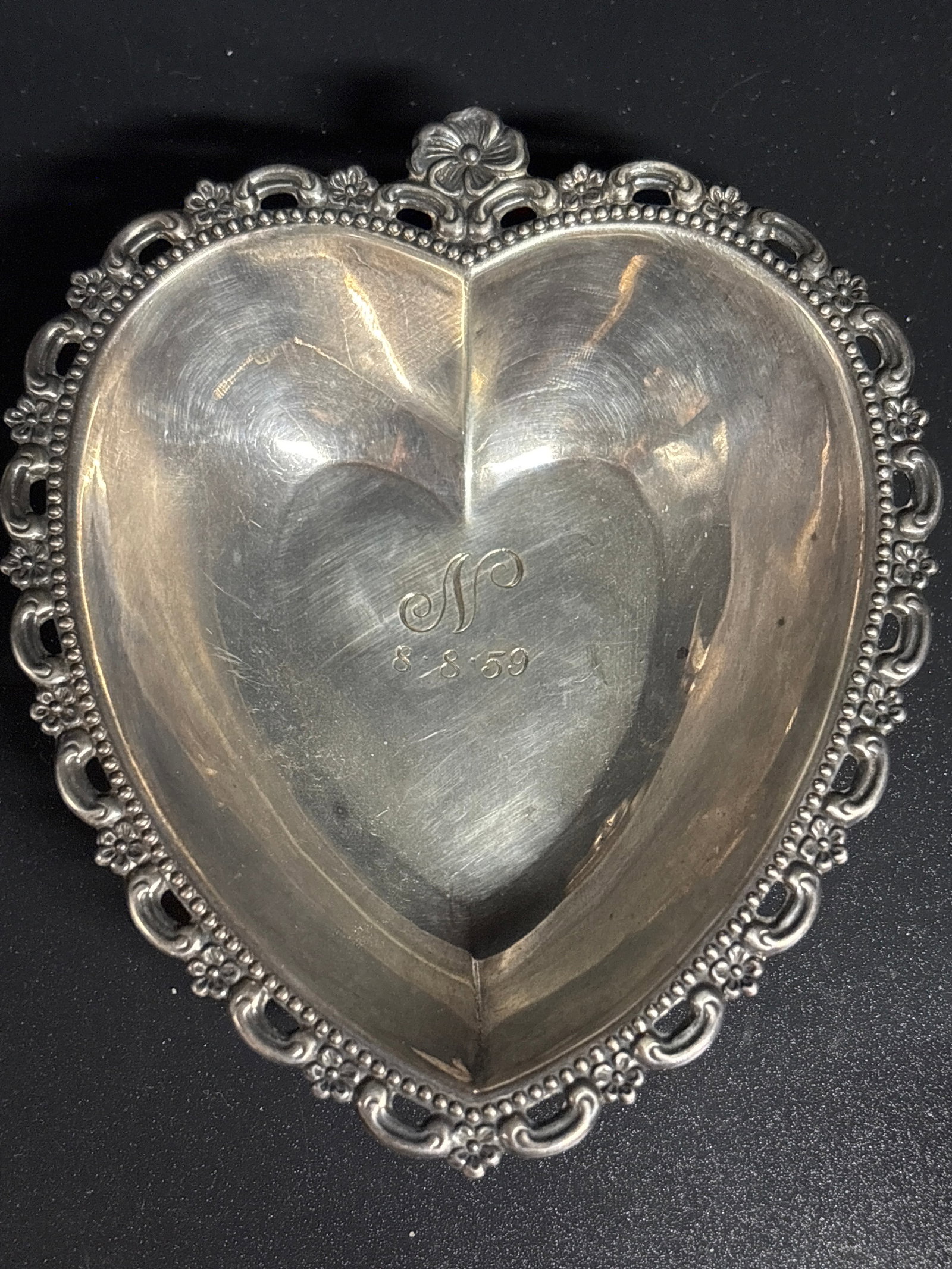 vintage Fisher Co. Sterling Silver heart-shaped trinket dish; 41 grams: vintage Fisher Sterling Silver heart-shaped trinket dish featuring a delicate floral and beaded border design. Material: Sterling Silver.Dimensions: Approximately 4 1/2 inches long by 3 3/4 inches wid