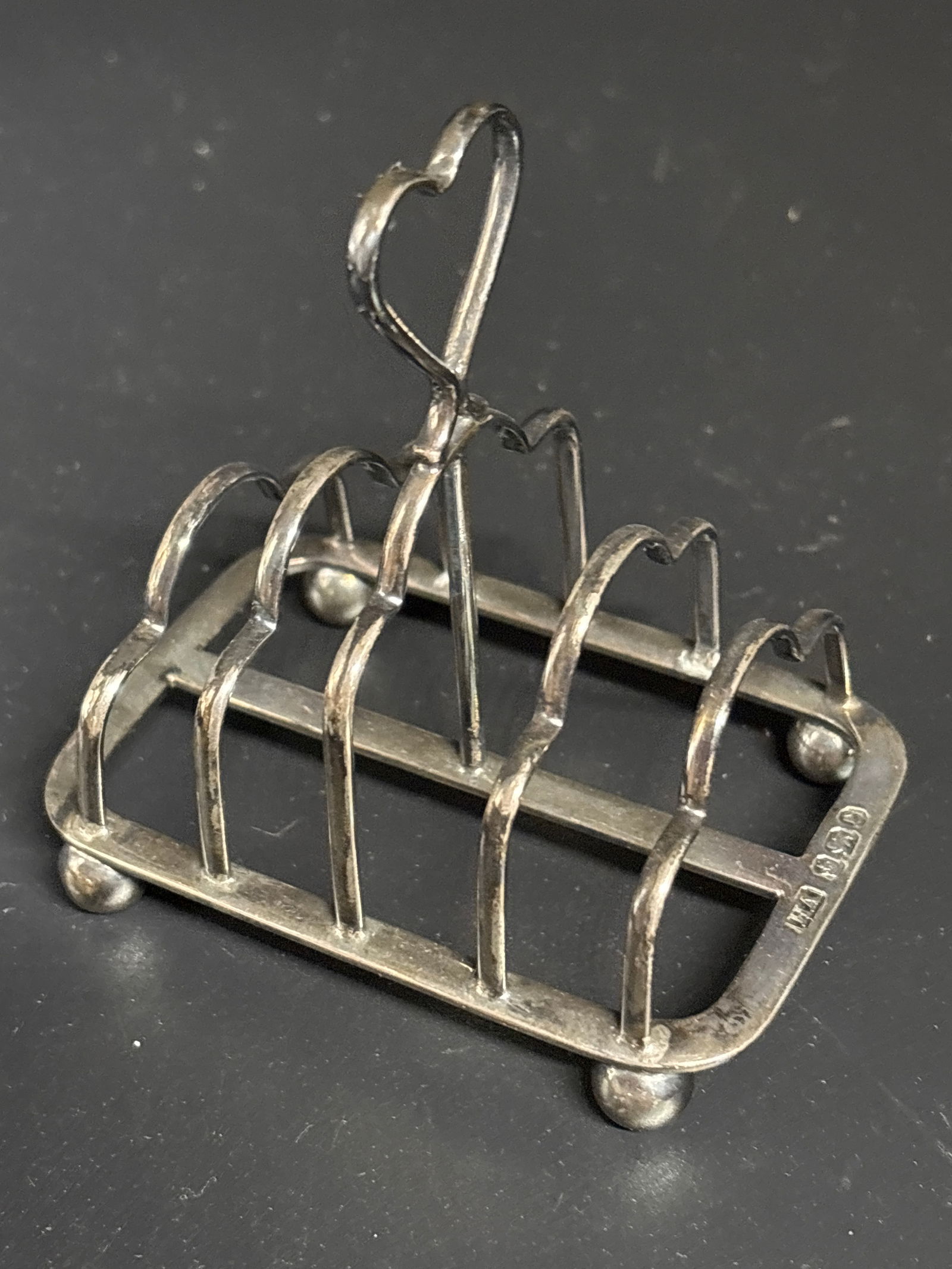 Small 3&1/2 inch antique English sterling silver toast rack; 60 grams: Small 3&1/2 inch antique English sterling silver toast rack, likely from the late 19th or early 20th century. Function: Designed to hold slices of toast upright to keep them crisp before serving. Desi