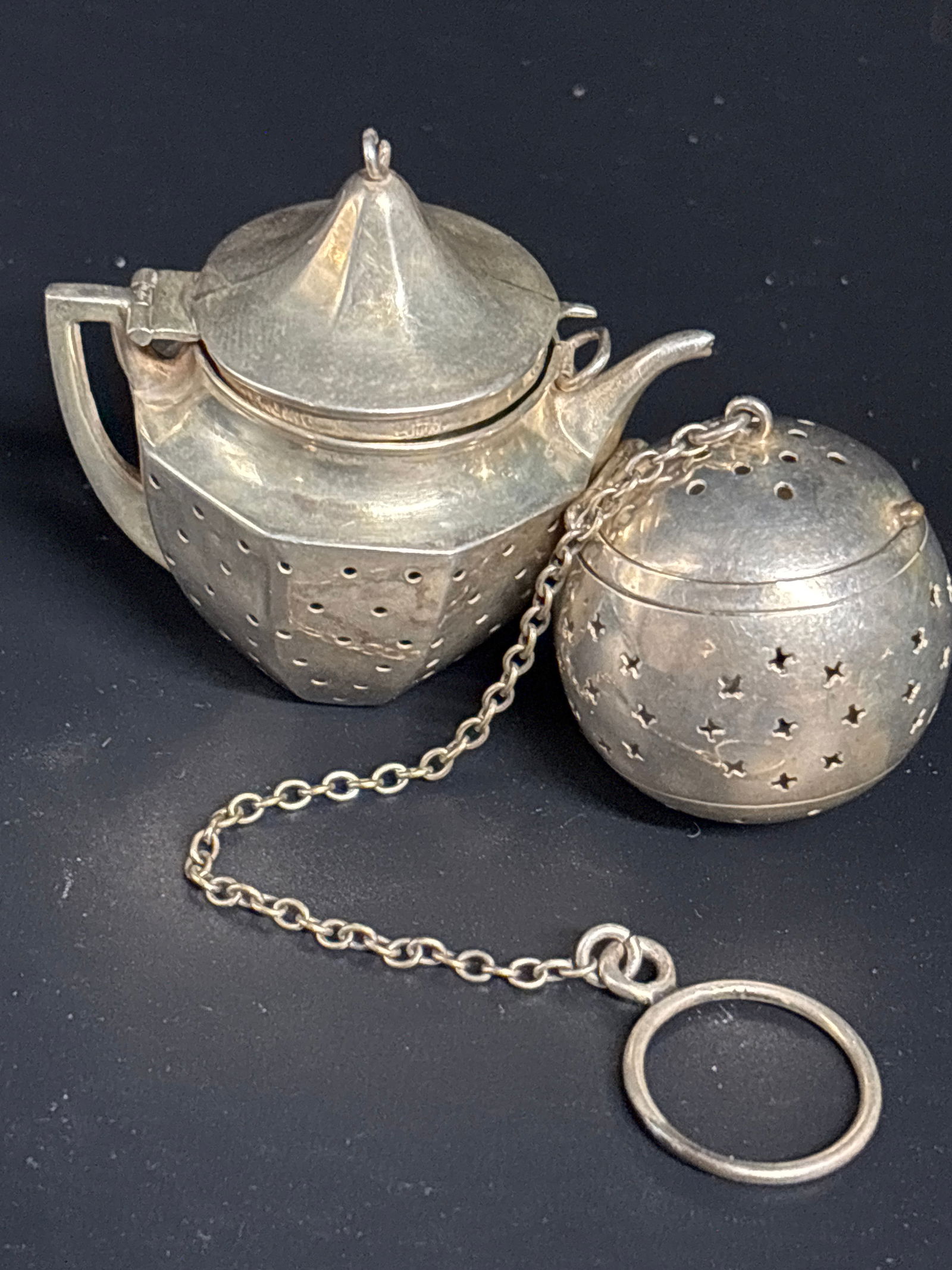 Two Sterling vintage-style tea infusers; 30 grams: Two Sterling vintage-style tea infuser designed to look like a miniature teapot and curricular tea ball.