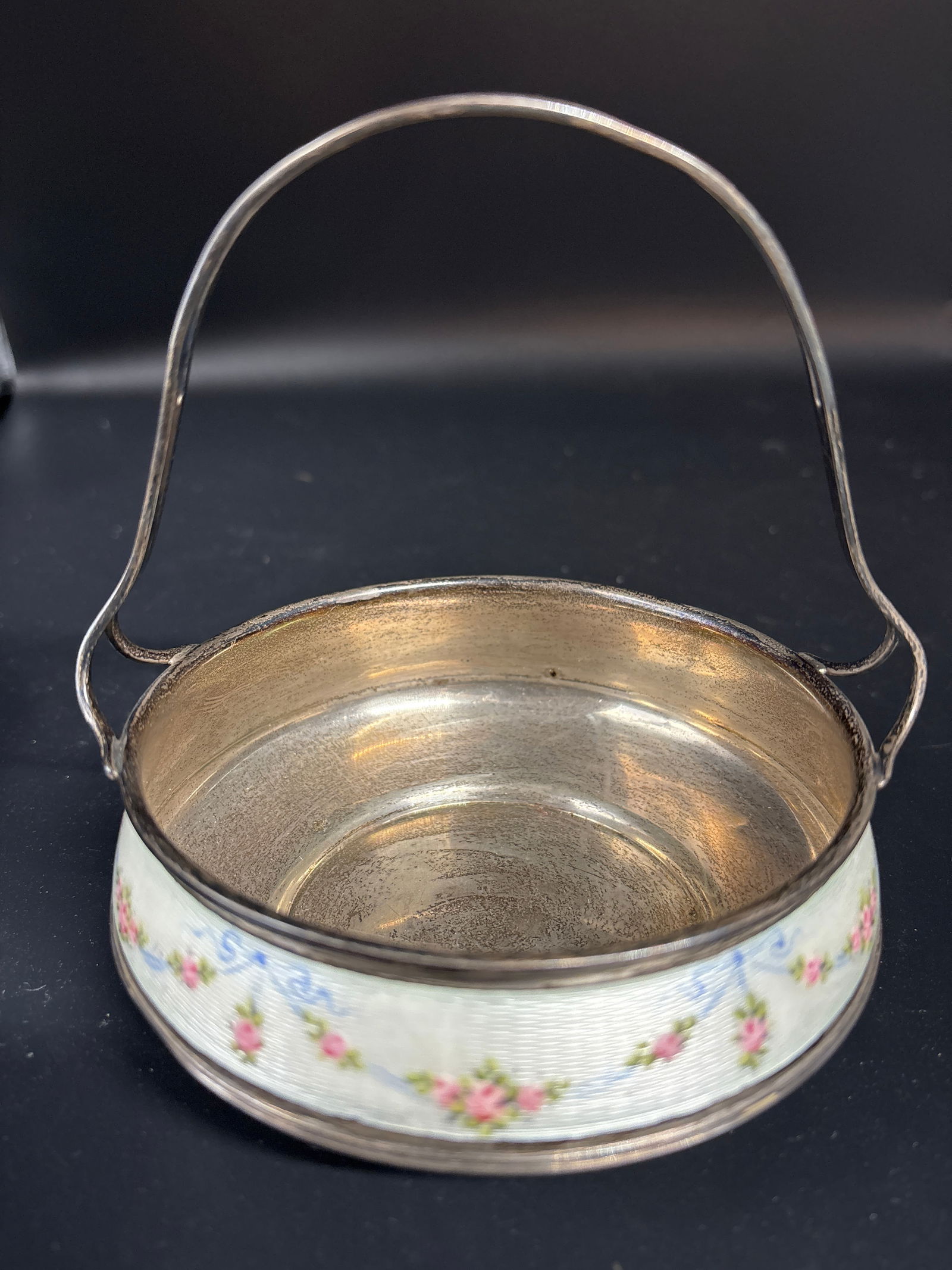 Heavy enameled sterling silver handled basket; 201 grams inclusive: enameled sterling silver sugar bowl or small decorative basket, likely featuring a floral pattern. Style: Antique or vintage decorative container, potentially Art Nouveau or similar period. Features: