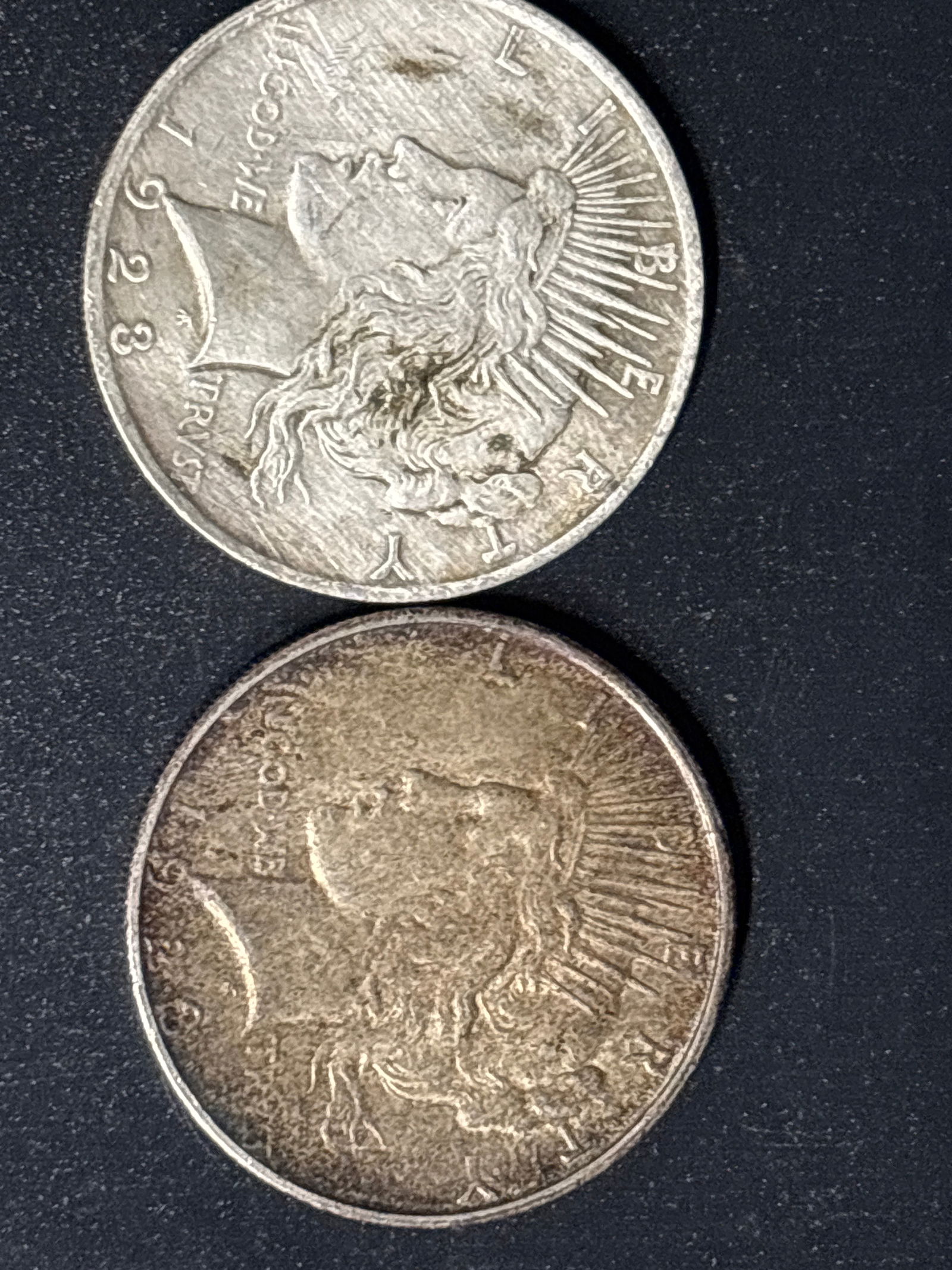 Two original 1923 Peace United States Silver Dollar.: 1923 United States Peace Silver Dollar, a collectible coin featuring the Goddess of Liberty on the obverse. Value: Circulated examples are generally worth between \$63 and \$72, depending on their con