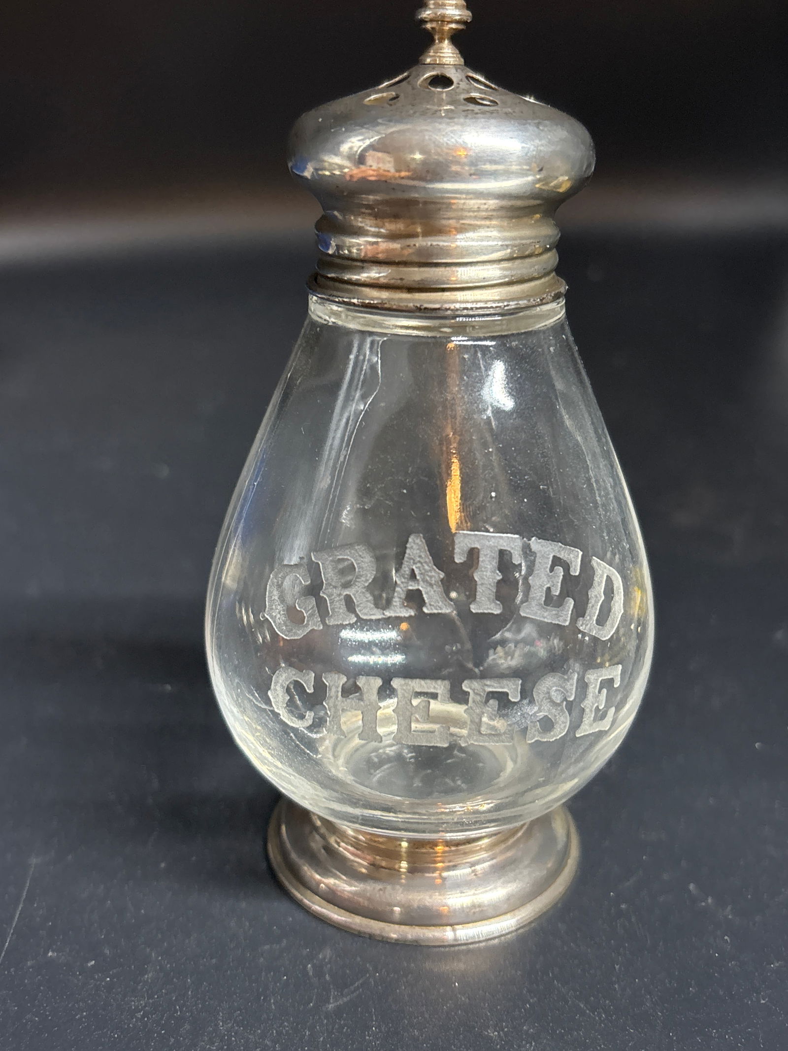 vintage Frank M. Whiting sterling silver and glass grated cheese shaker: vintage Frank M. Whiting sterling silver and glass grated cheese shaker, likely dating from the early 20th century. Manufacturer: Frank M. Whiting & Company of North Attleboro, Massachusetts. Material