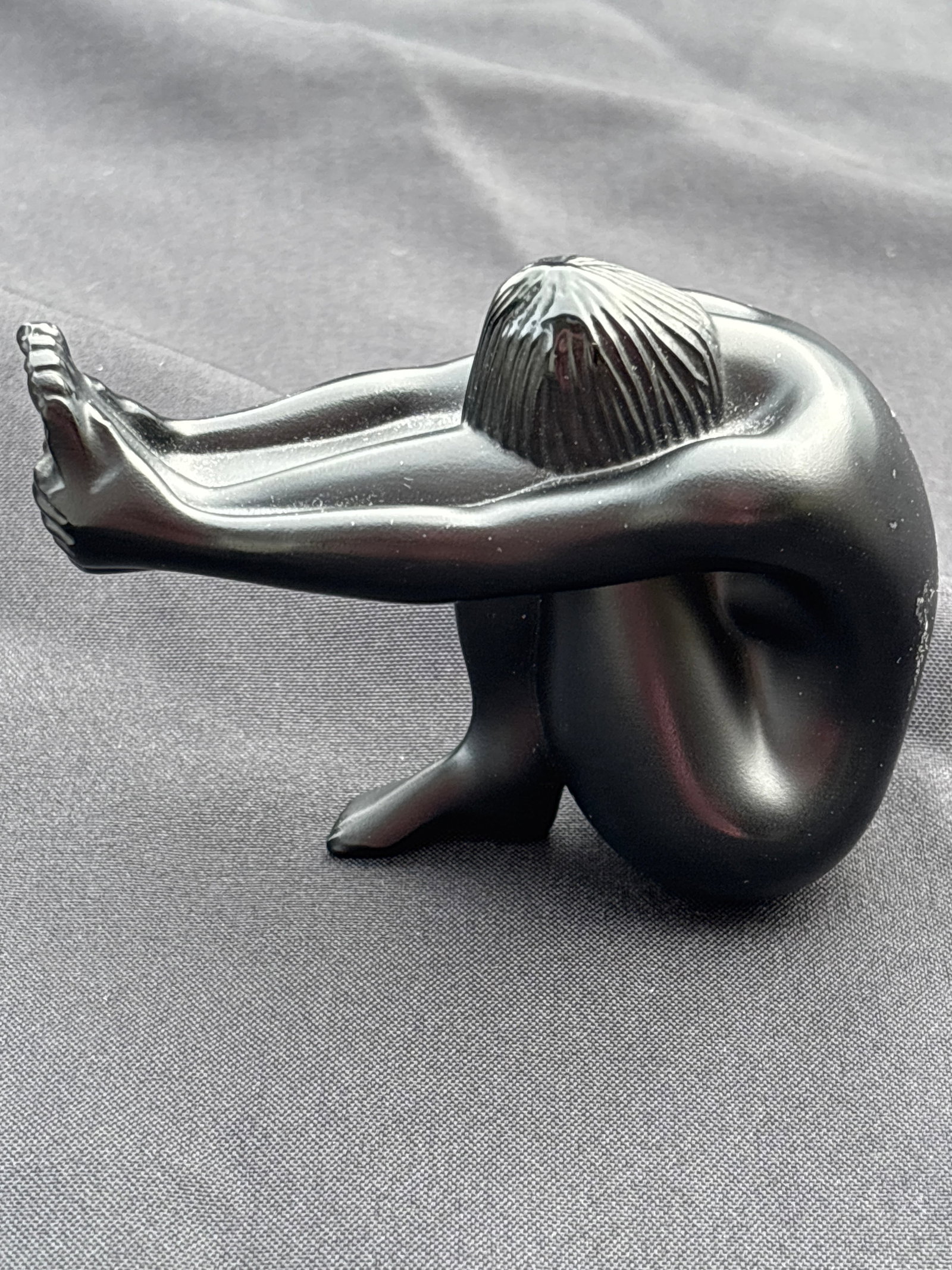Signed Lalique French black crystal 3.5 inch Nu Assis (seated nude) sculpture: Signed Lalique black crystal sculpture from the Lalique "Yoga Nudes" collection. Specifically, this pose—a seated nude figure with leg extended her arms wrapped around her knees and head tucked—is