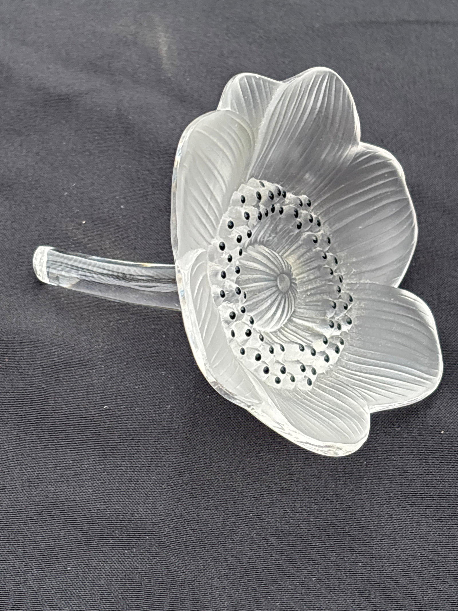 Original Lalique French crystal ‘Anemone’ flower: Lalique Anemone Sculpture, a decorative crystal flower paperweight. Material: Crafted from clear and frosted lead crystal, accented with black enamel on the flower's center. Dimensions: Approximately