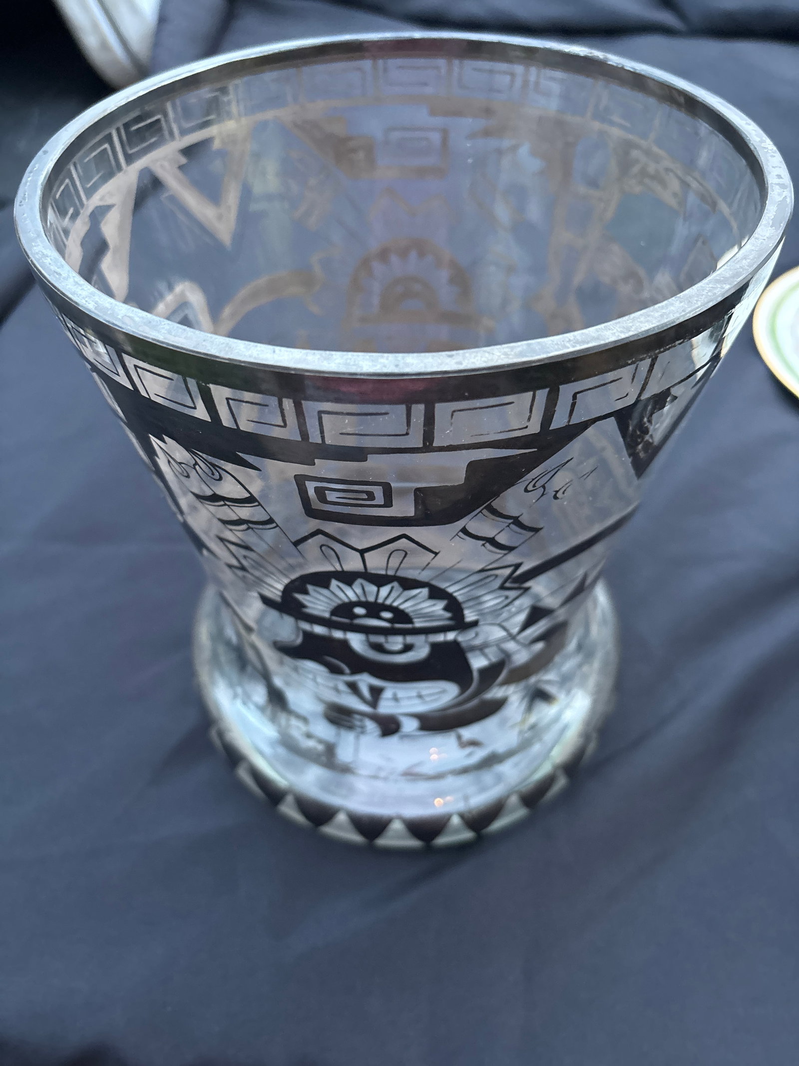 Large 9&1/4 inch vintage collectible glass vase featuring a silver overlay in a Mayan or Aztec motif: vintage collectible glass vase featuring a silver overlay in a Mayan or Aztec motif, likely dating from the 1950s. Design: Features black and white geometric patterns and a depicted warrior or god fig