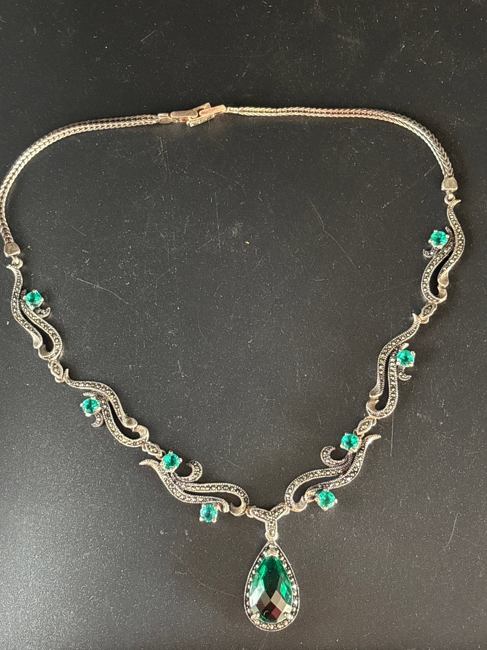 .925 pear-cut (teardrop) green gemstone suspended from curved, multi-stone bib; 28 grams inclusive (1 of 7)