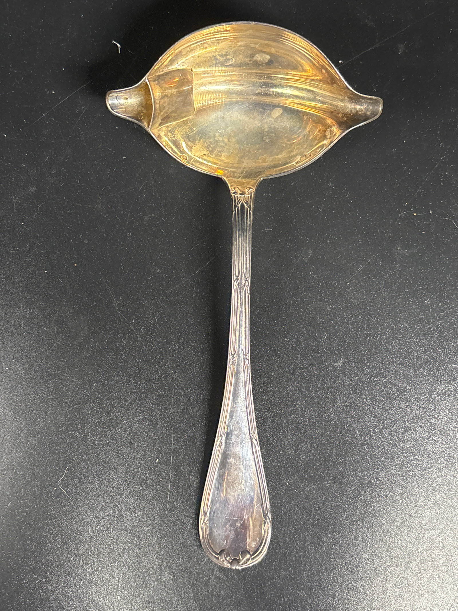 Christofle silver-plated sauce or gravy ladle featuring a double-spout bowl; no monogram: silver-plated sauce or gravy ladle featuring a double-spout bowl. It is from the Rubans collection (also known as Rubans Croisés) by the French silversmith Christofle.Key DetailsPattern: Created in 1